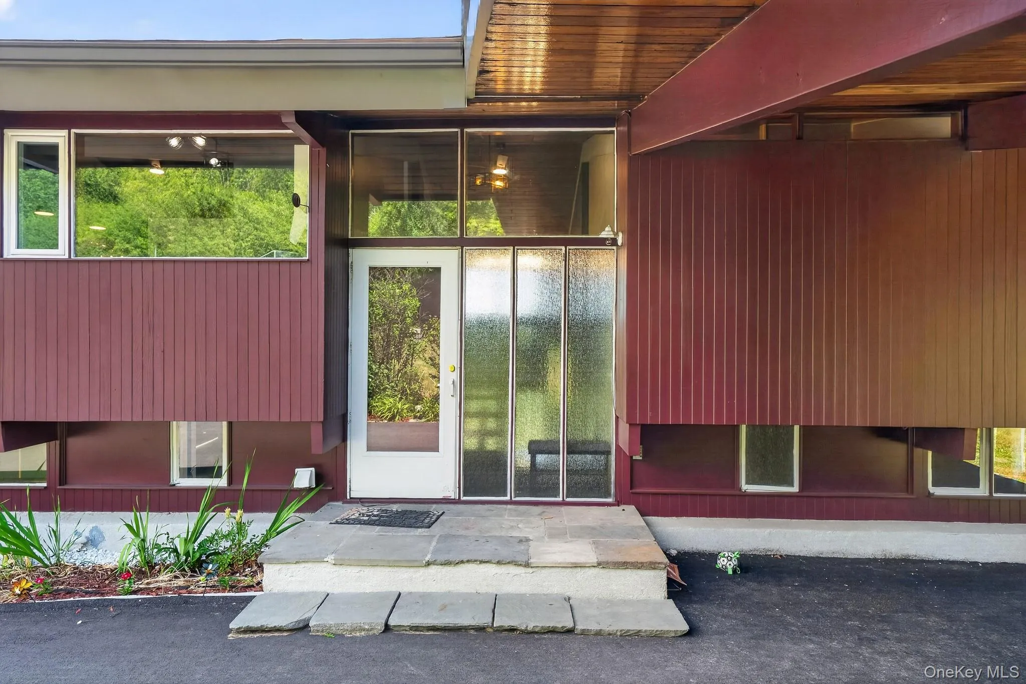 Modern architectural facade featuring rich vertical siding panels and expansive fenestration Modern architectural facade featuring rich vertical siding panels and expansive fenestration