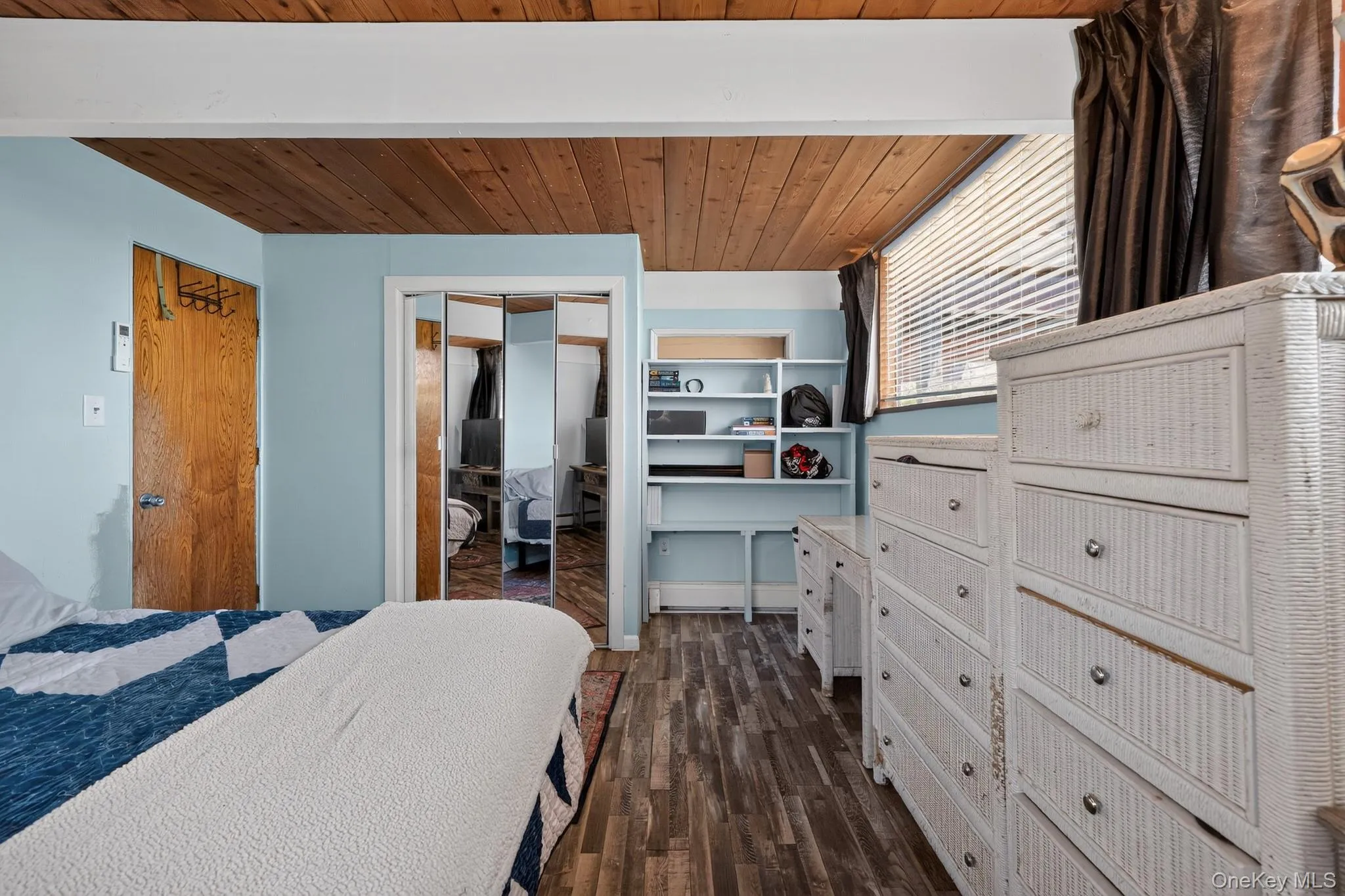 Wood-finish flooring throughout, complemented by a wood-paneled ceiling with exposed beams Wood-finish flooring throughout, complemented by a wood-paneled ceiling with exposed beams