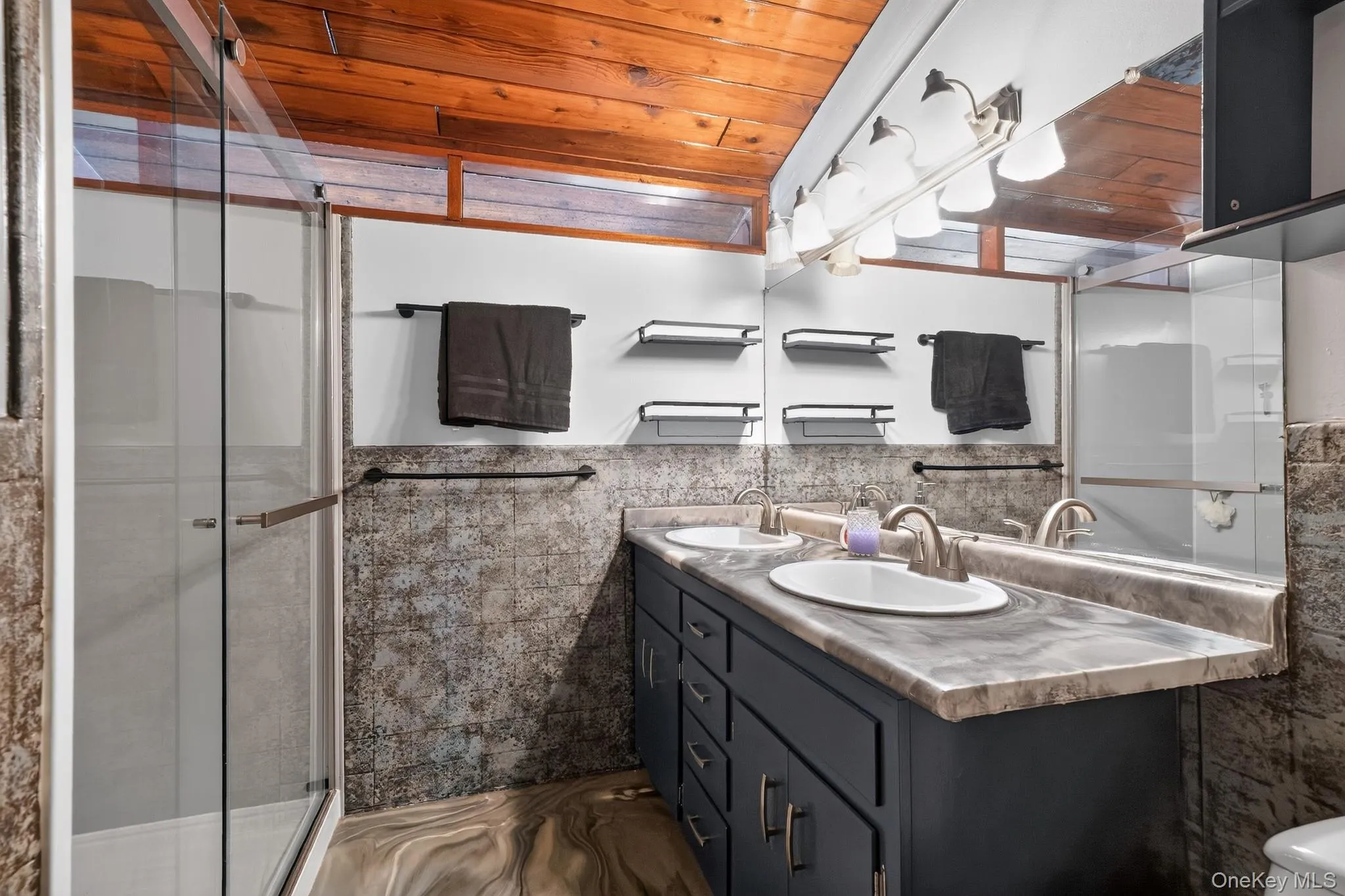 Dual vanity with under-sink cabinetry, integrated sinks, and coordinating countertop Dual vanity with under-sink cabinetry, integrated sinks, and coordinating countertop