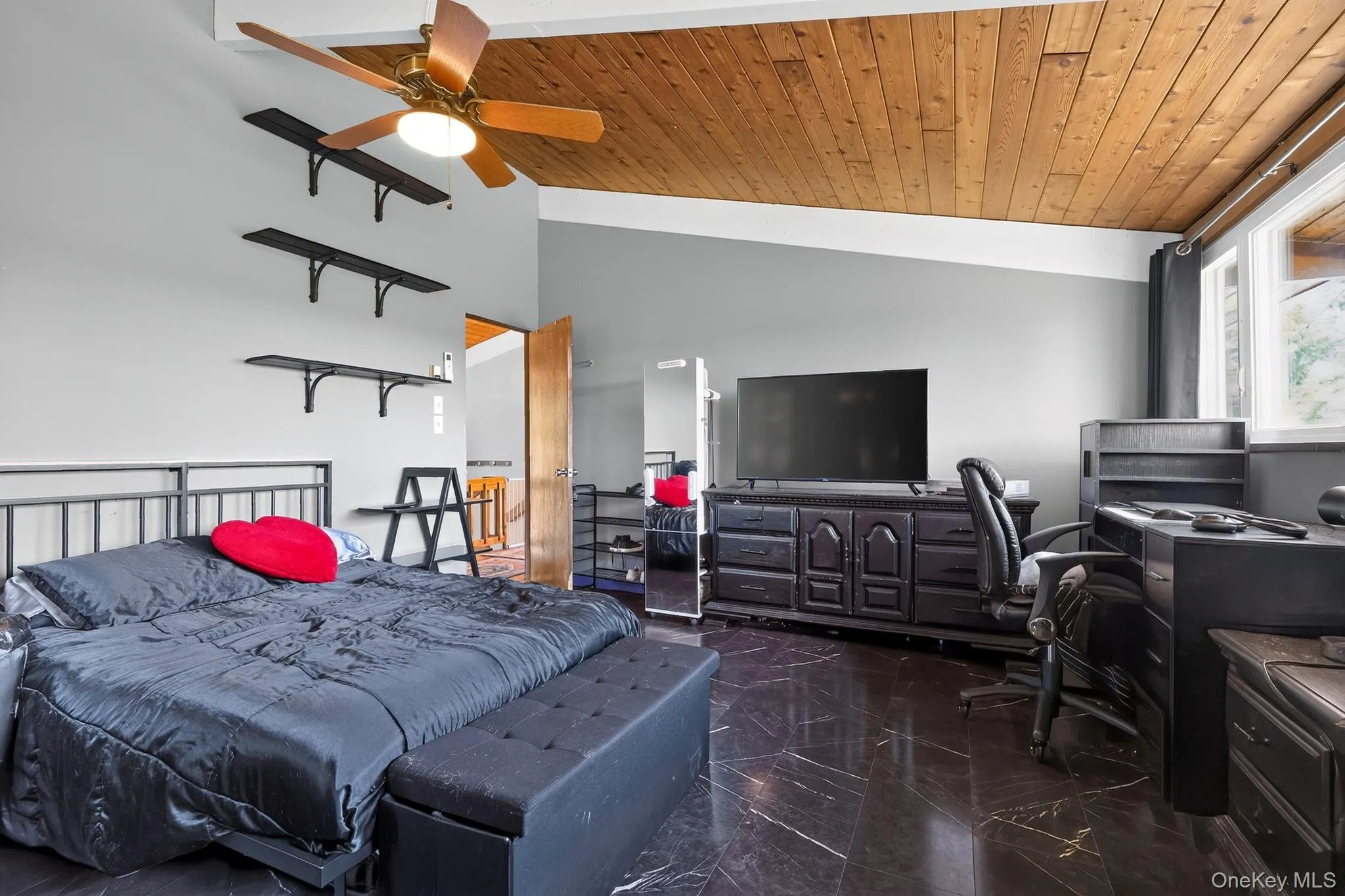 Vaulted wood-plank ceiling with a ceiling fan Vaulted wood-plank ceiling with a ceiling fan