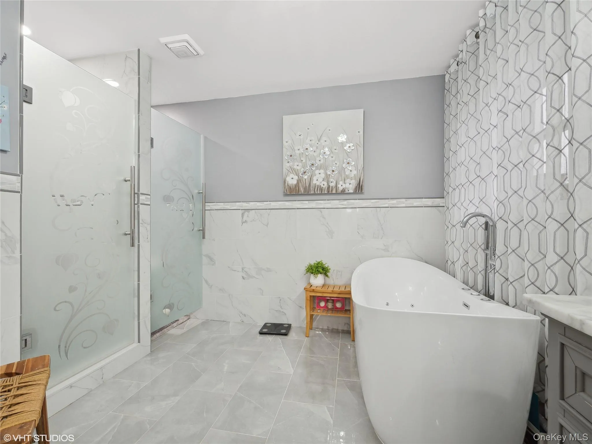 Bathroom with plus walk in shower, vanity, and tile walls Bathroom with plus walk in shower, vanity, and tile walls