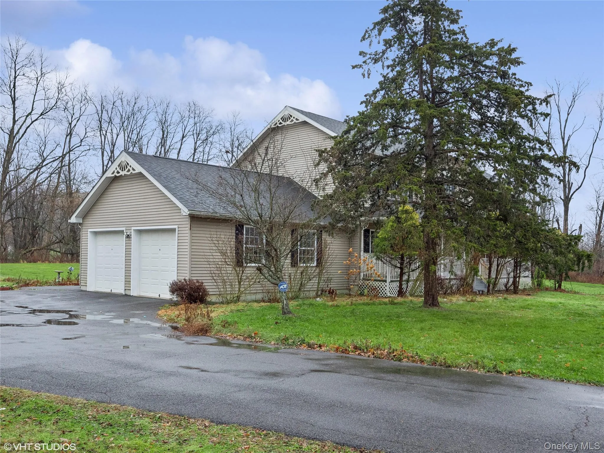 View of front of home featuring a front yard and a garage View of front of home featuring a front yard and a garage