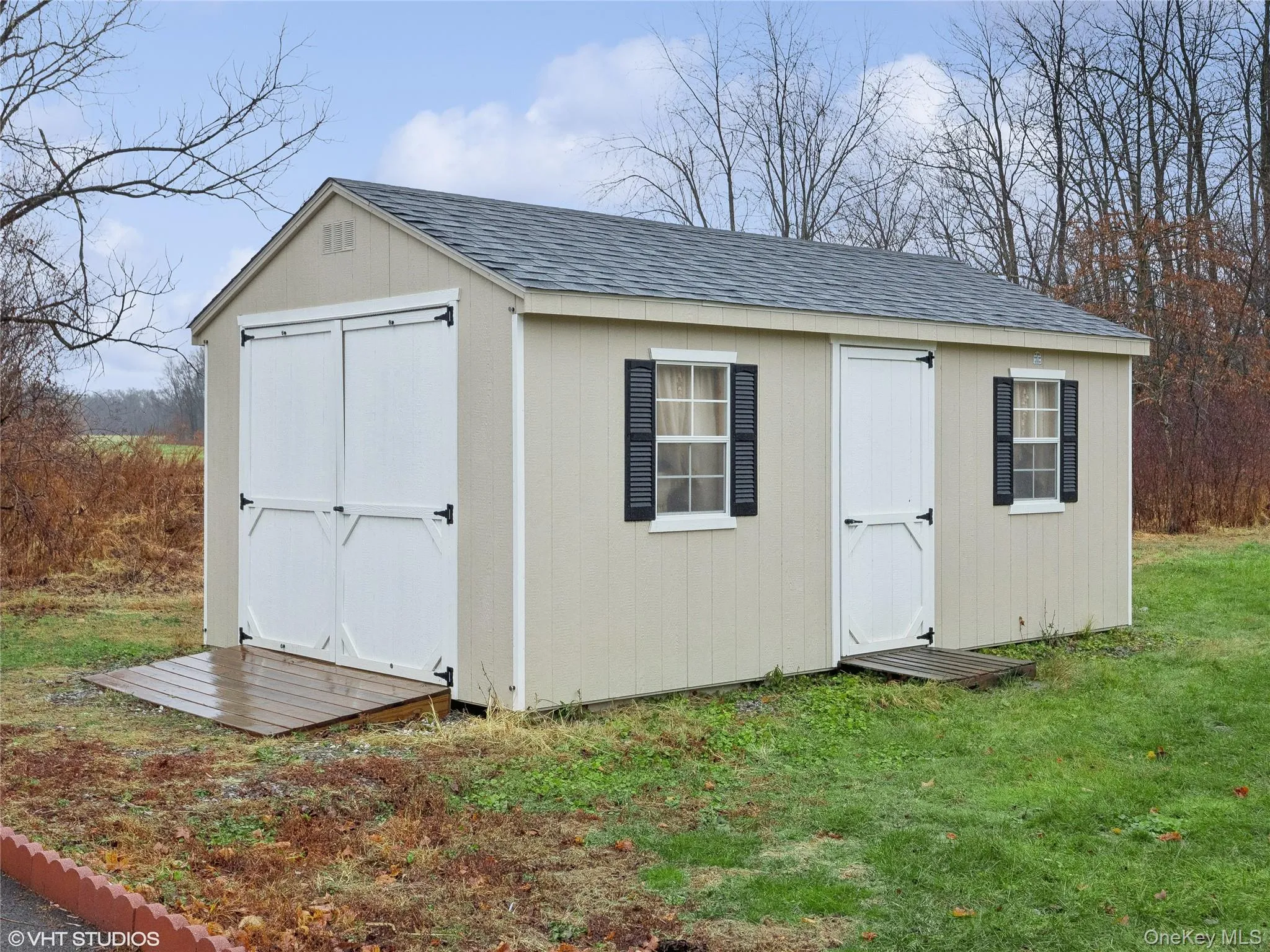 View of outdoor structure with a lawn View of outdoor structure with a lawn