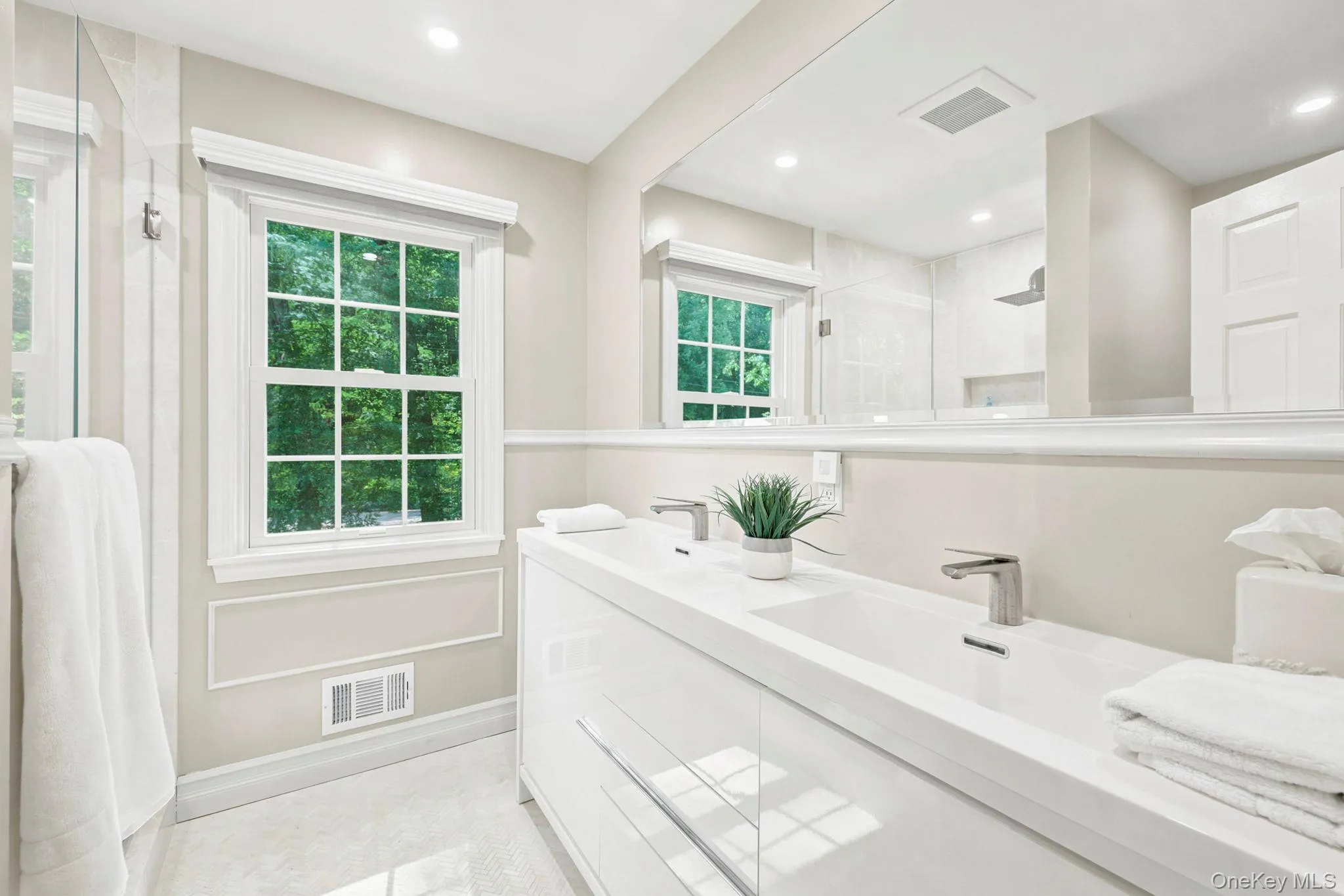 Primary bathroom with walk-in shower and dual sink vanity with storage Primary bathroom with walk-in shower and dual sink vanity with storage