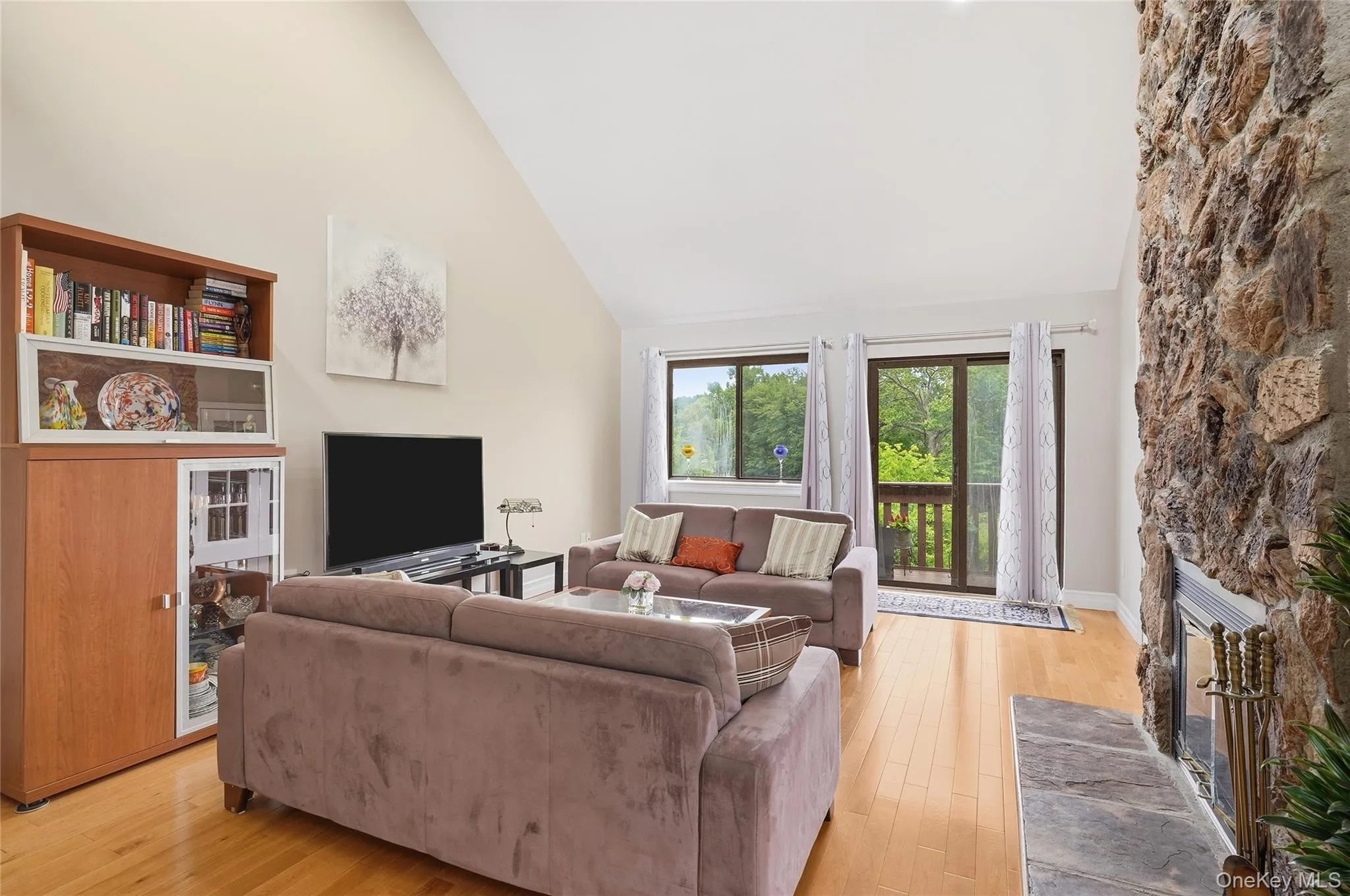 Spacious Living room with sliders out to a spacious deck. Spacious Living room with sliders out to a spacious deck.
