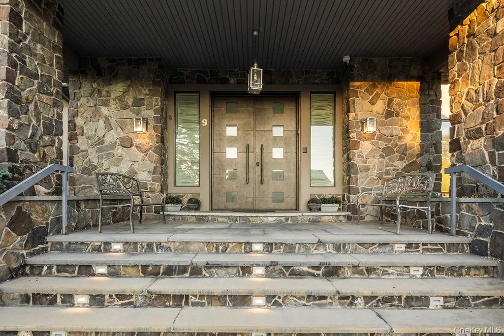 Stone facade entry featuring double doors with square glass inserts Stone facade entry featuring double doors with square glass inserts