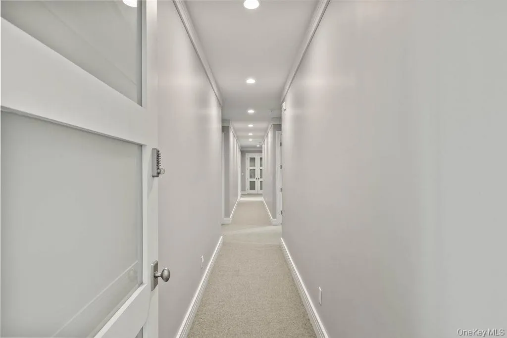 Hallway featuring recessed lighting, light-toned walls, and carpet flooring Hallway featuring recessed lighting, light-toned walls, and carpet flooring