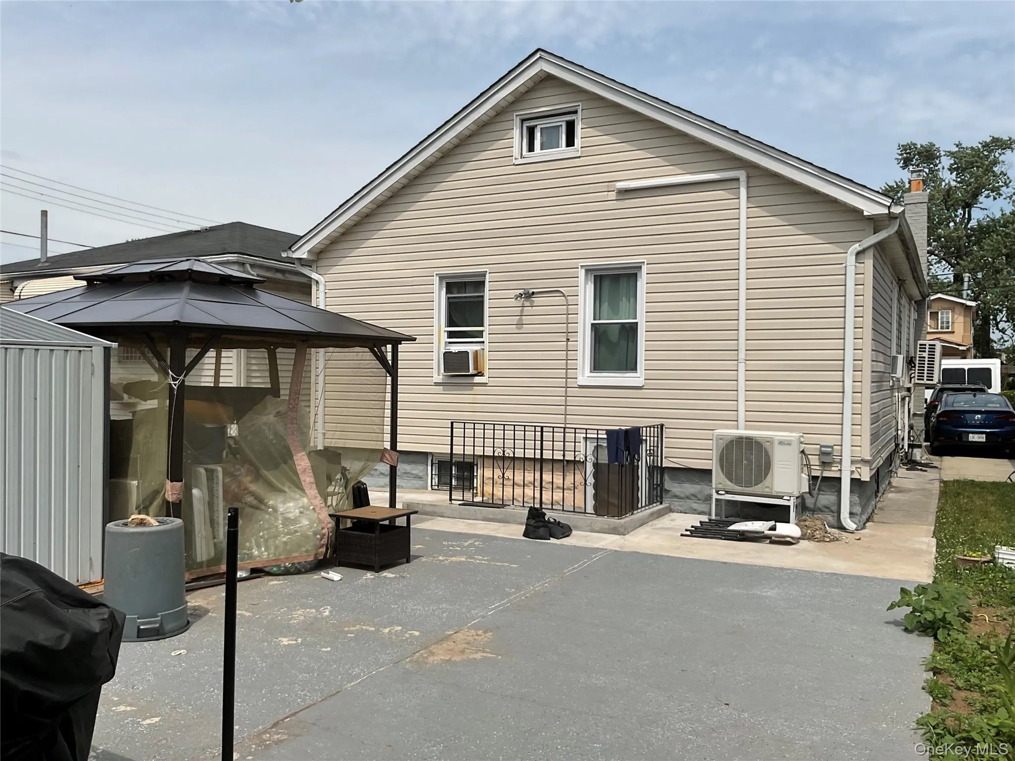 Rear exterior of the property featuring horizontal siding and a gabled roofline Rear exterior of the property featuring horizontal siding and a gabled roofline