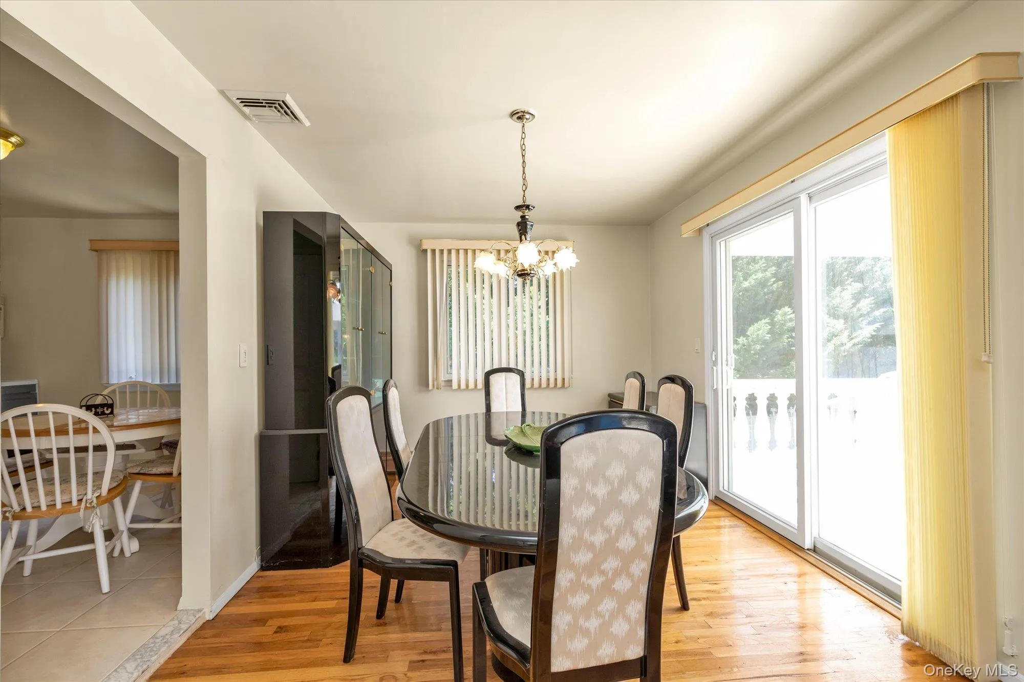 Upper-level dining room w/ sliders to patio Upper-level dining room w/ sliders to patio
