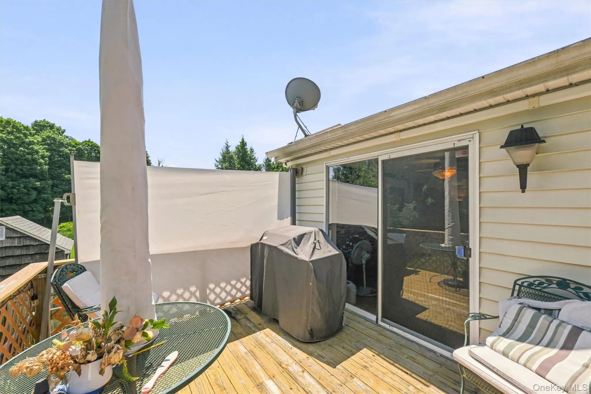 Wood-finish deck with privacy screening and lattice railing Wood-finish deck with privacy screening and lattice railing