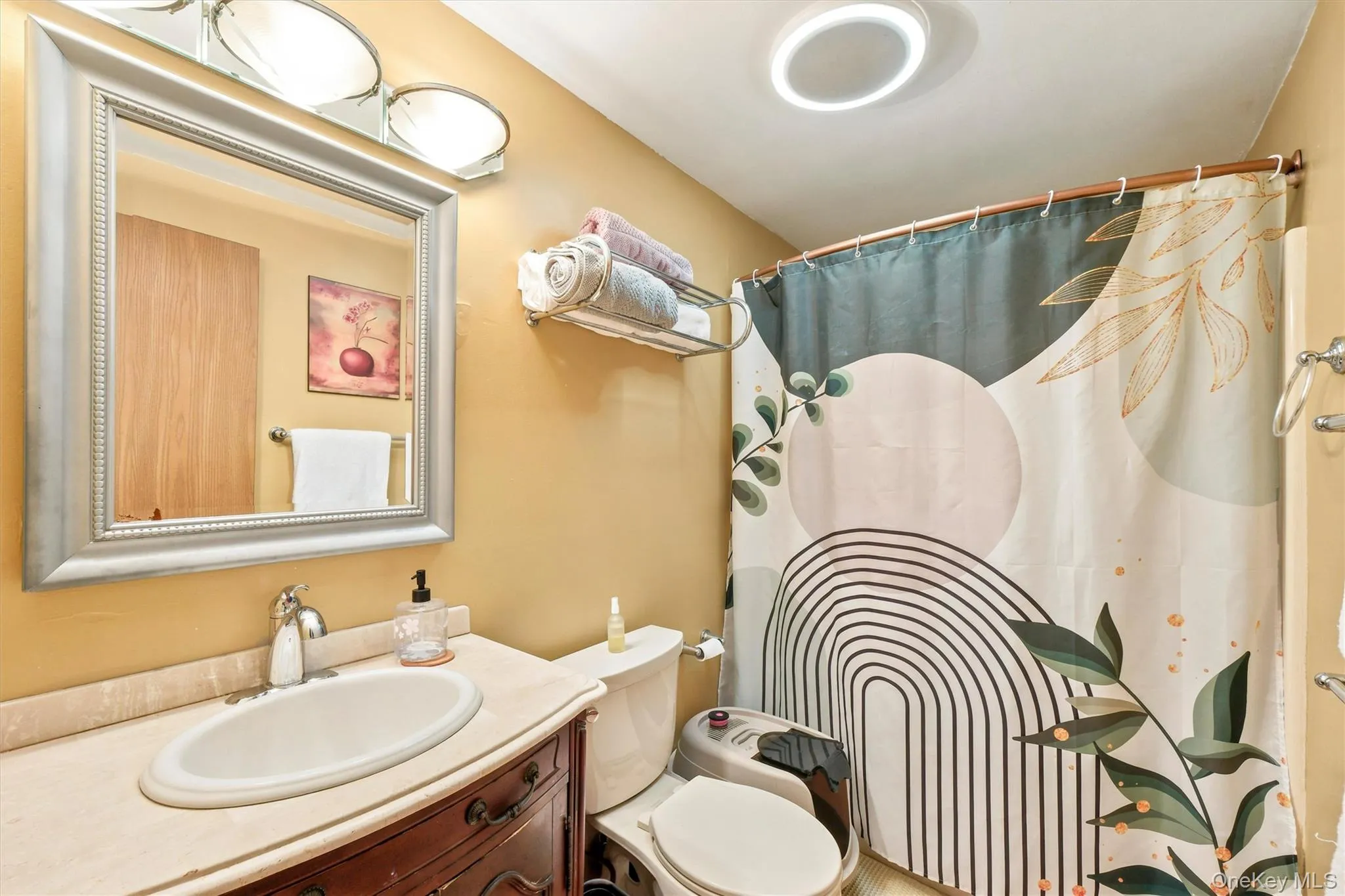 Bathroom vanity featuring an integrated sink with a polished chrome faucet, set within a light-toned countertop Bathroom vanity featuring an integrated sink with a polished chrome faucet, set within a light-toned countertop