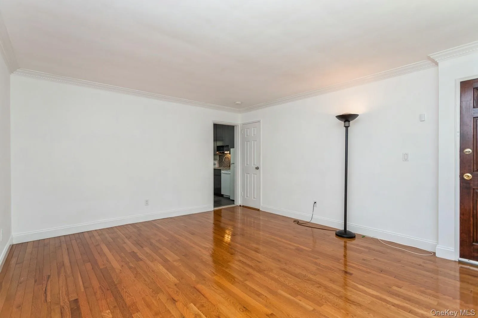 Unfurnished room with wood finished floors and crown molding Unfurnished room with wood finished floors and crown molding
