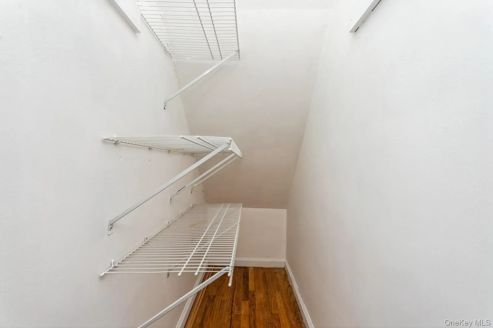 Walk in closet featuring wood finished floors Walk in closet featuring wood finished floors