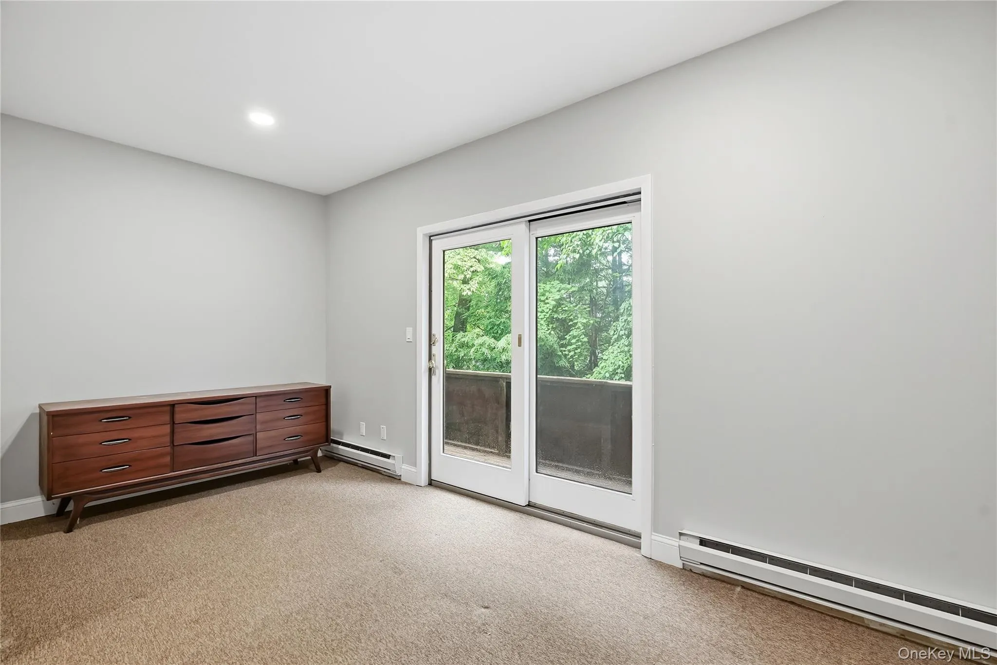 Lower level bedroom with sliders and a walk in closet Lower level bedroom with sliders and a walk in closet