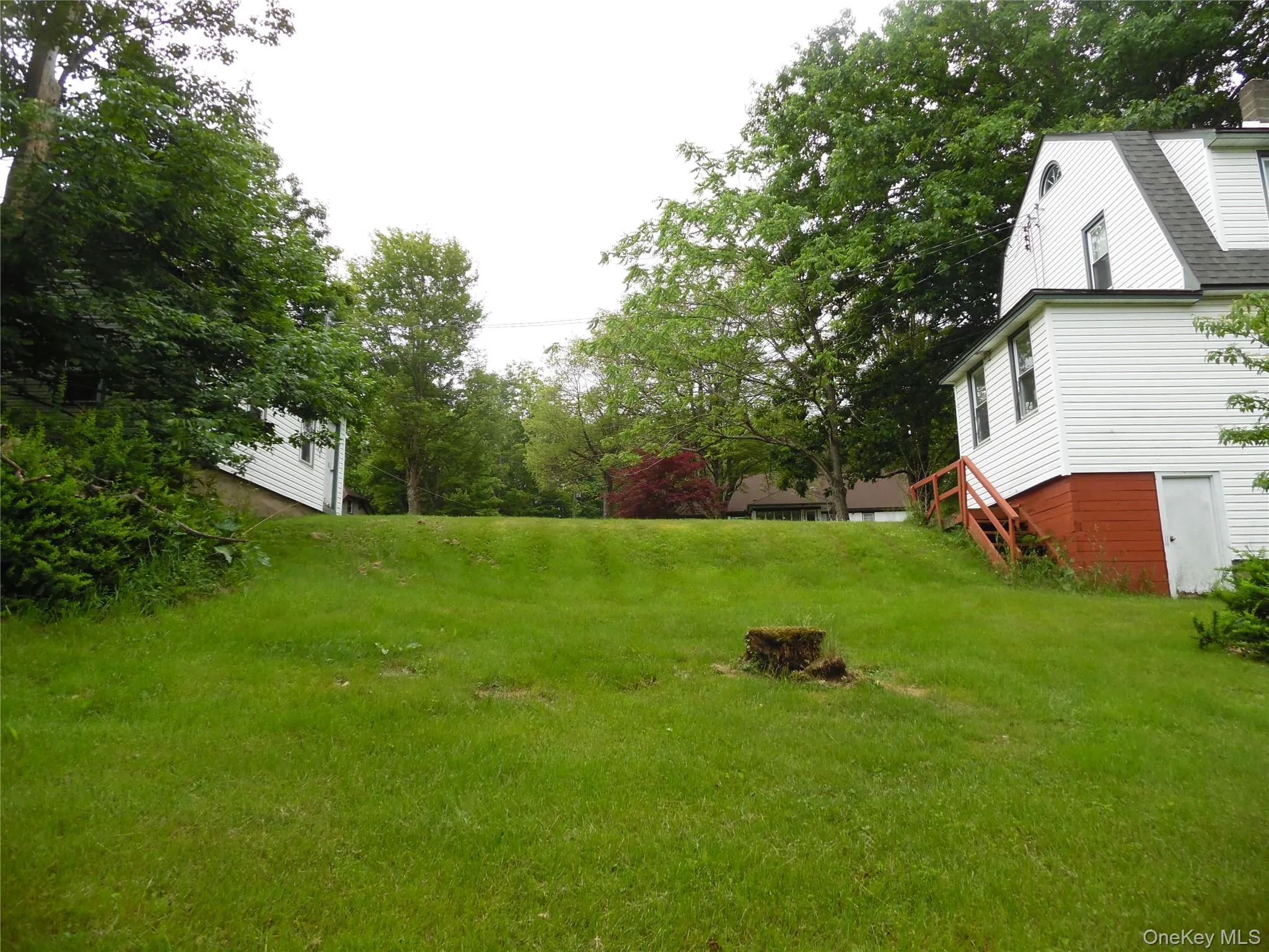 Back of property looking up. Garage on left and house on right Back of property looking up. Garage on left and house on right