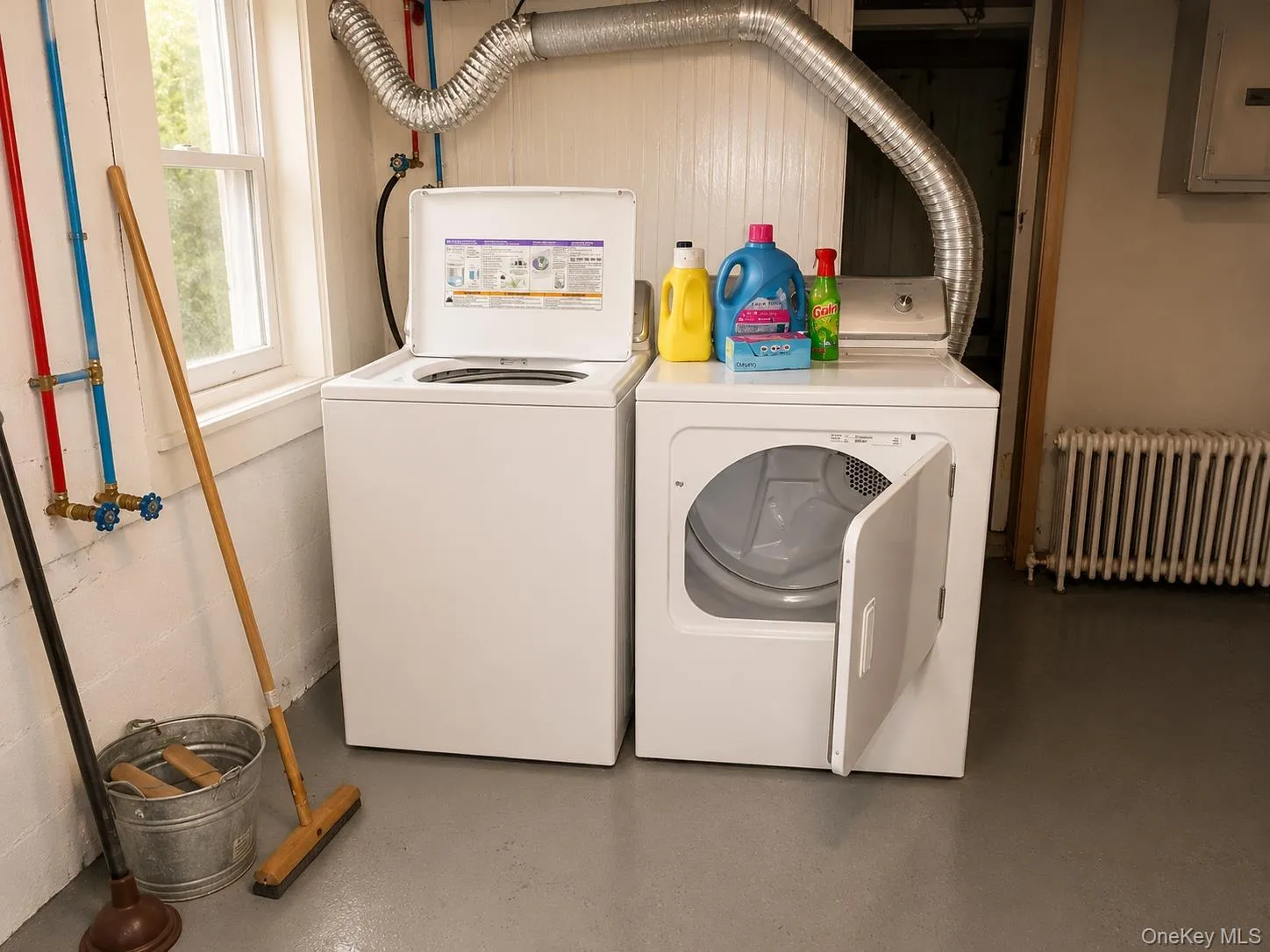 Dedicated laundry area featuring a white washing machine and dryer Dedicated laundry area featuring a white washing machine and dryer