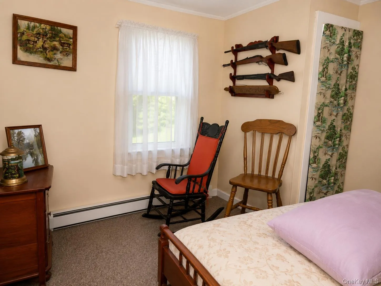 Bedroom, Carpeted room featuring a single window with white sheers, baseboard heating, and light-colored walls Bedroom, Carpeted room featuring a single window with white sheers, baseboard heating, and light-colored walls