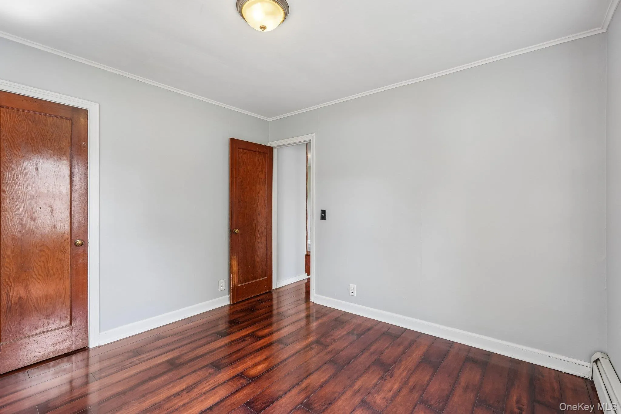 Bedroom with hardwood flooring. Bedroom with hardwood flooring.