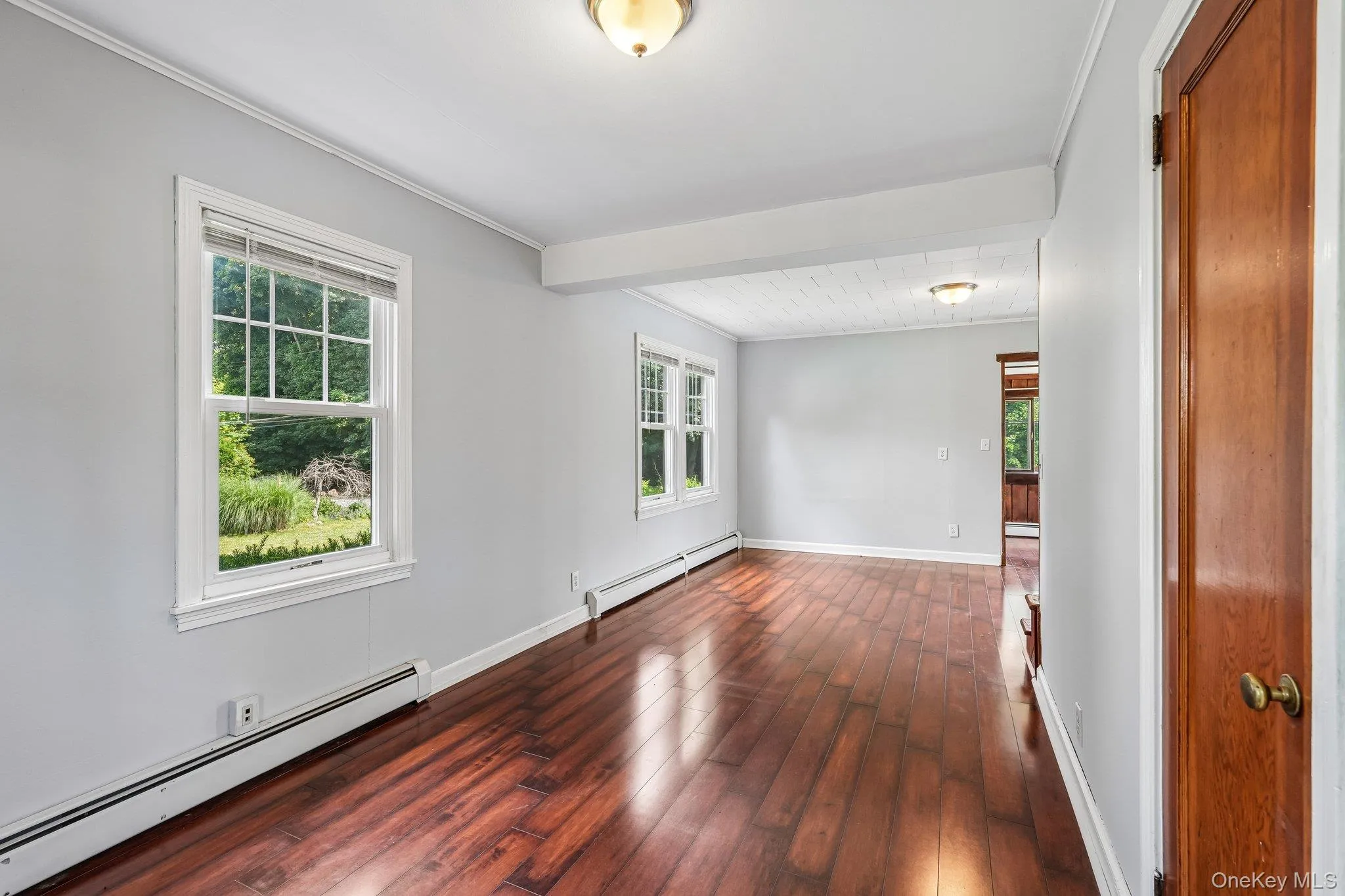 Living room with gleaming hardwood floors. Living room with gleaming hardwood floors.