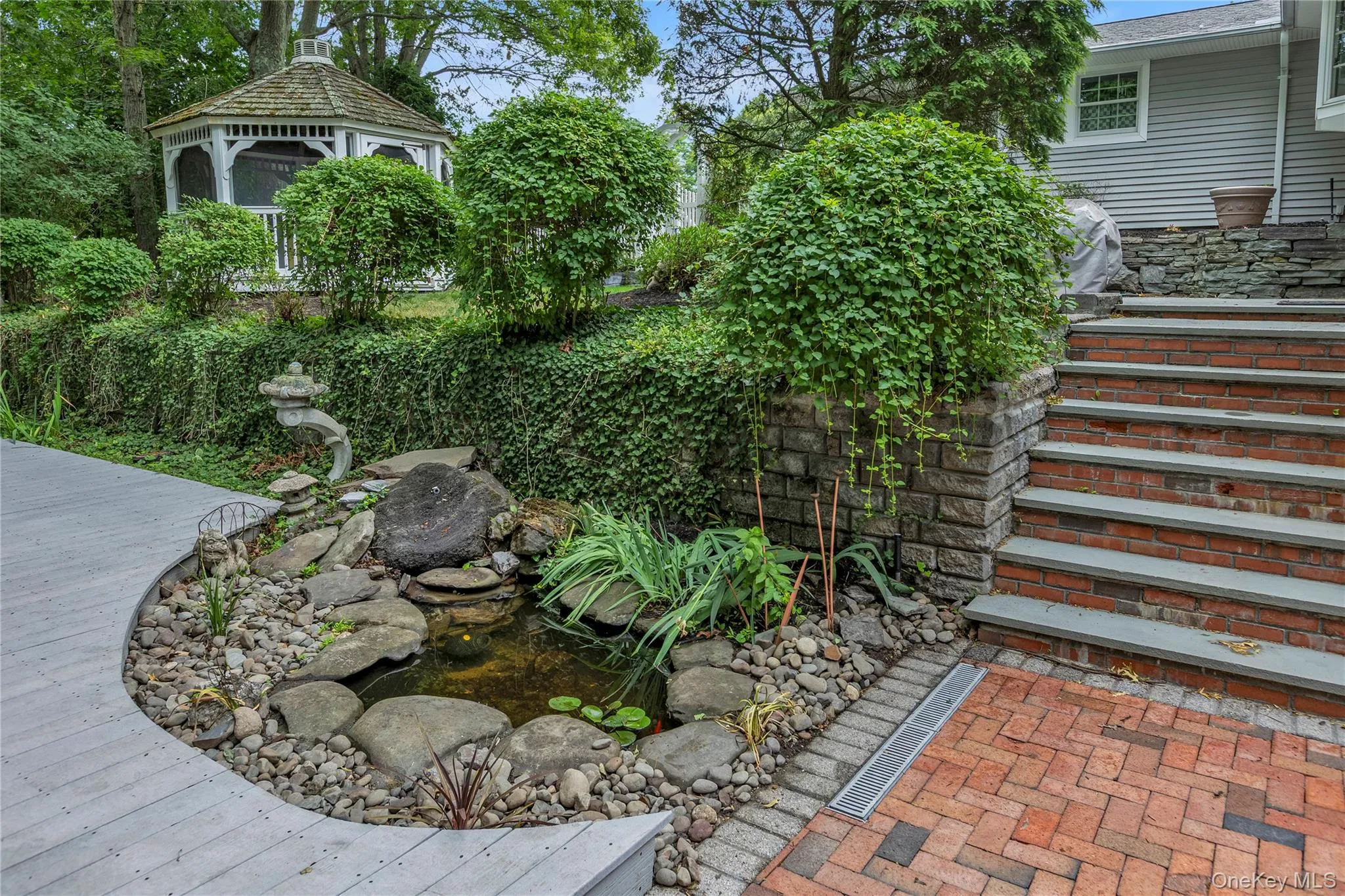 Steps from patio to pool level. Koi pond. Steps from patio to pool level. Koi pond.