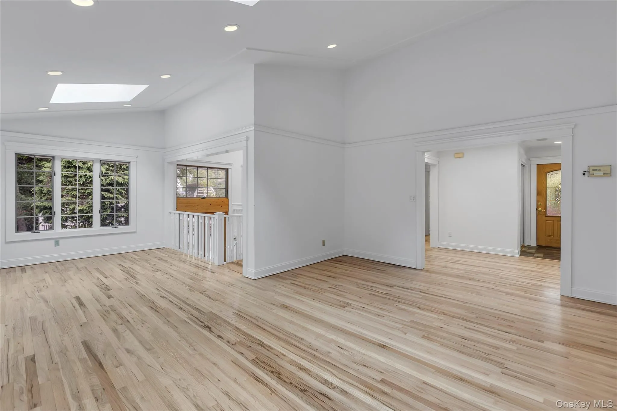 View of Living Room- Dining Room and entrance foyer. Staircase to lower level. View of Living Room- Dining Room and entrance foyer. Staircase to lower level.
