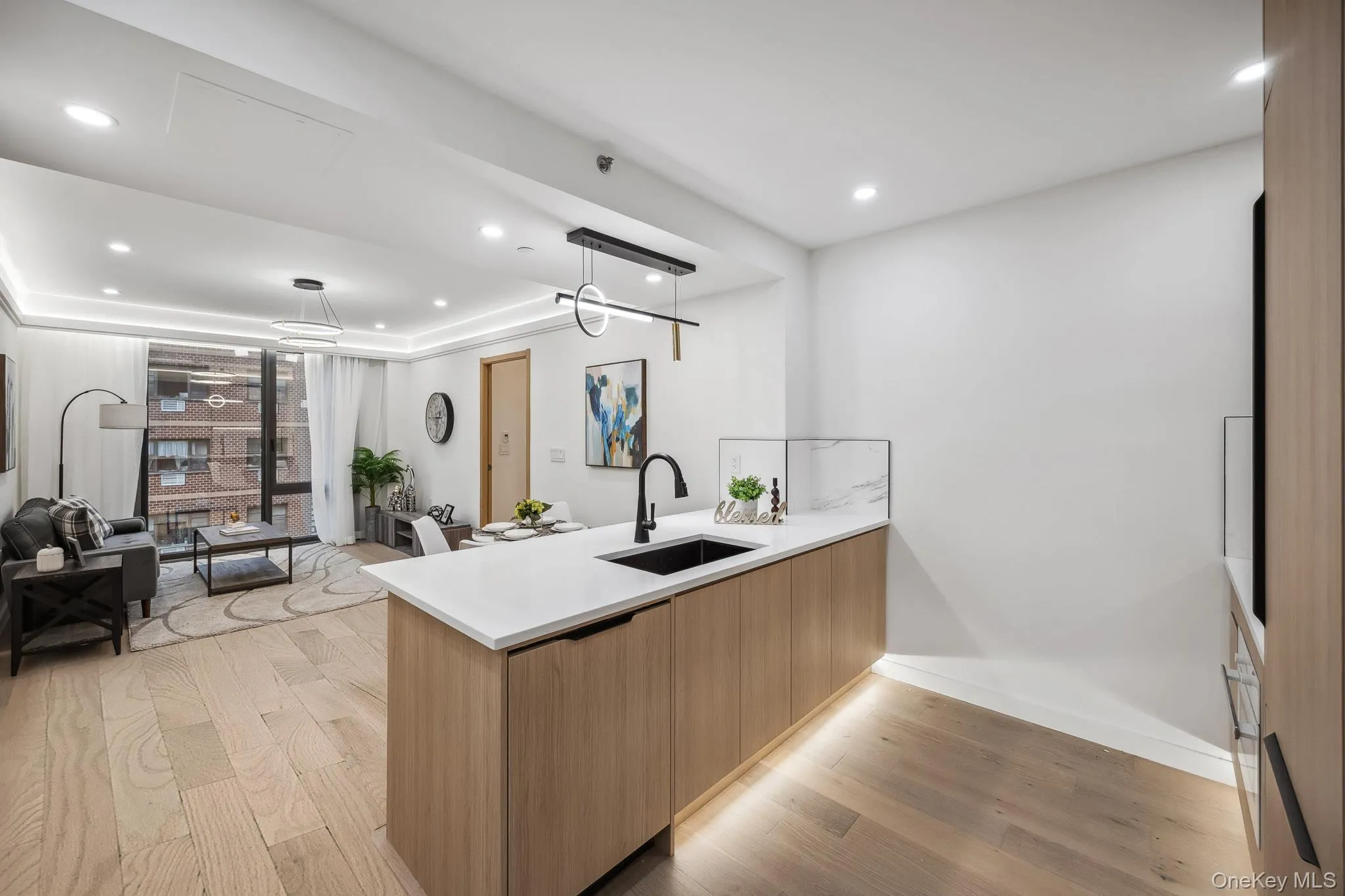 Kitchen with a sink, modern cabinets, light wood-style flooring, a peninsula, and open floor plan Kitchen with a sink, modern cabinets, light wood-style flooring, a peninsula, and open floor plan