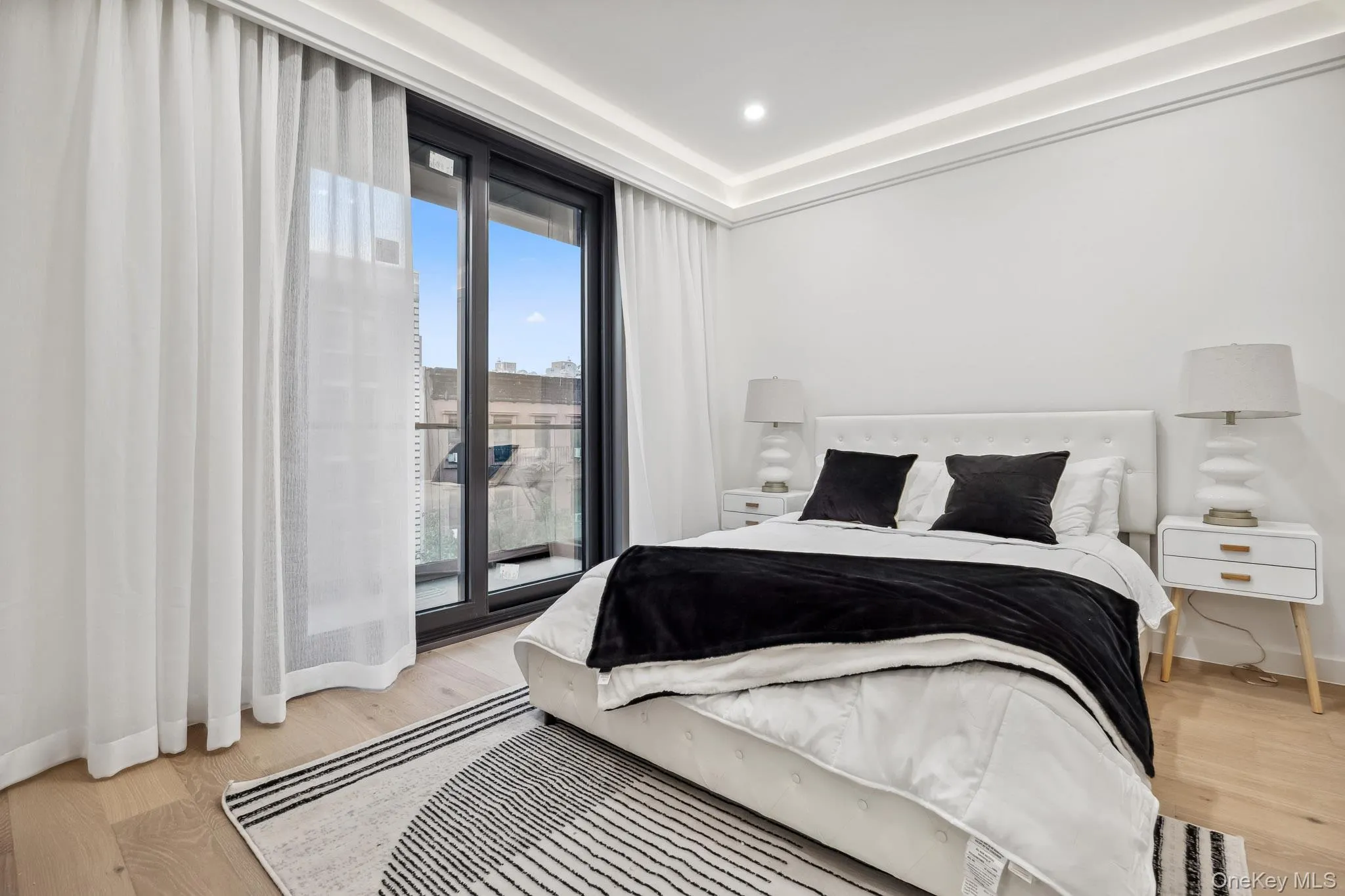 Bedroom featuring light wood-type flooring, baseboards, access to outside, and recessed lighting Bedroom featuring light wood-type flooring, baseboards, access to outside, and recessed lighting