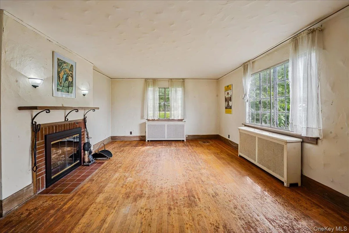 Living Room with wood burning fireplace and hardwood floors Living Room with wood burning fireplace and hardwood floors