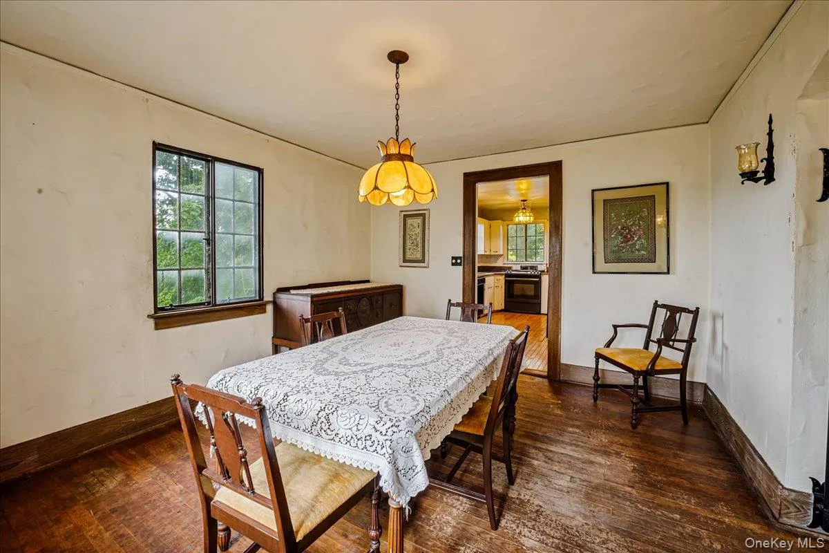 Dining room off living room with hardwood floors leading into Kitchen Dining room off living room with hardwood floors leading into Kitchen