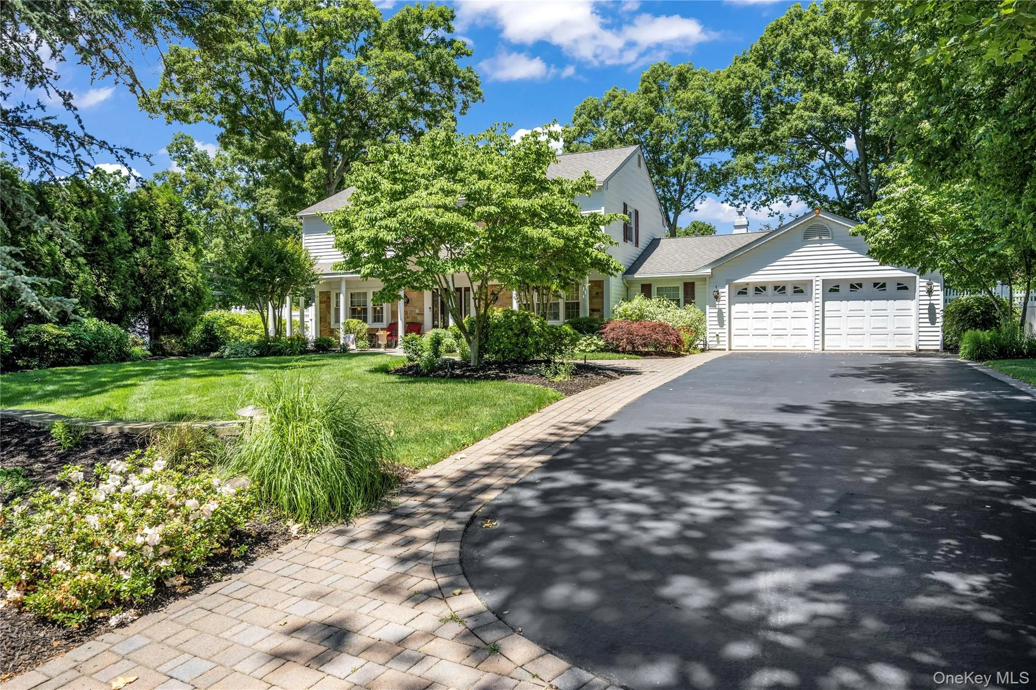 Traditional white siding residence with a two-car garage Traditional white siding residence with a two-car garage