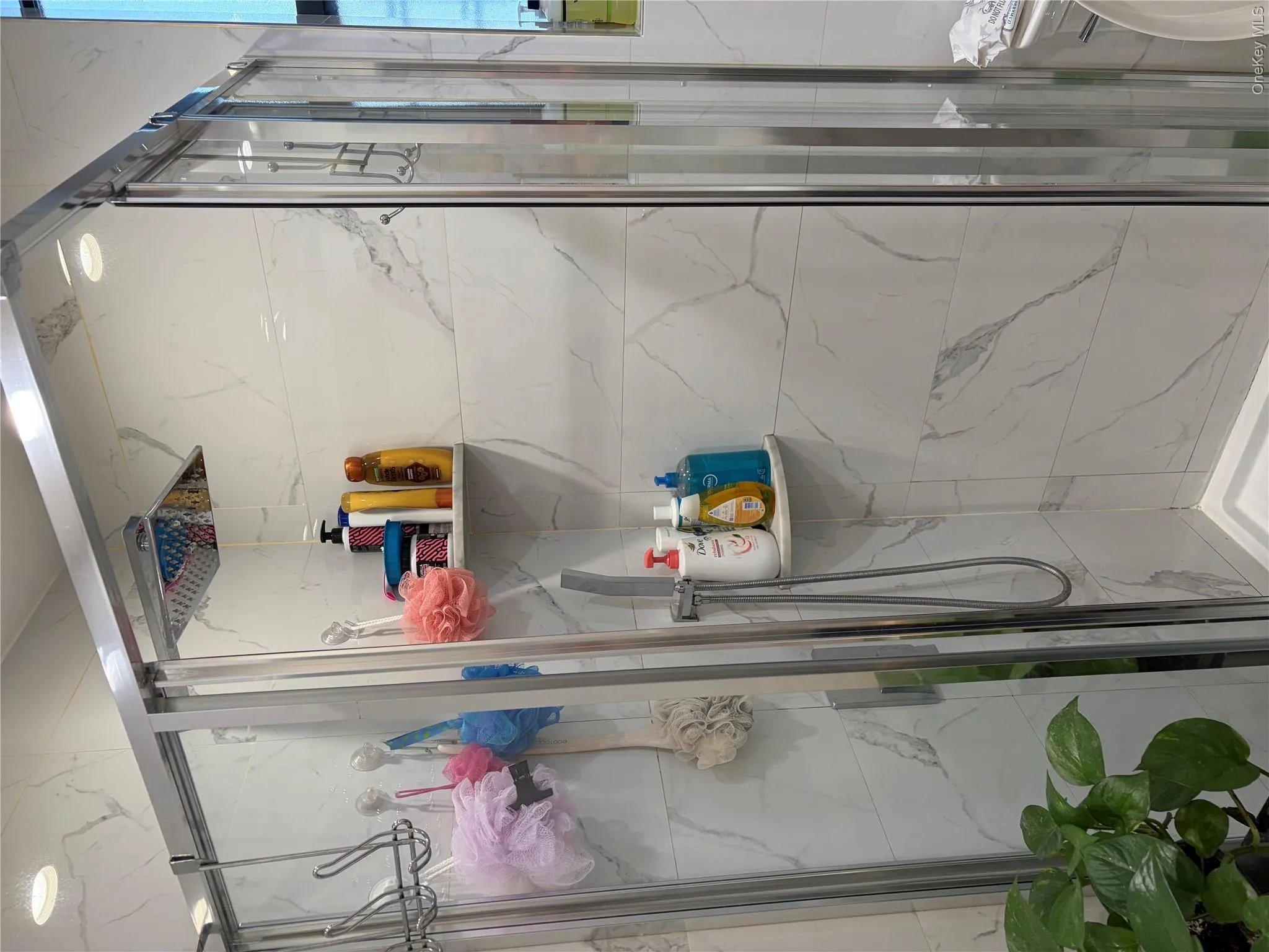 Bathroom stand up shower (no tub) Walls covered in marble tiles. Bathroom stand up shower (no tub) Walls covered in marble tiles.