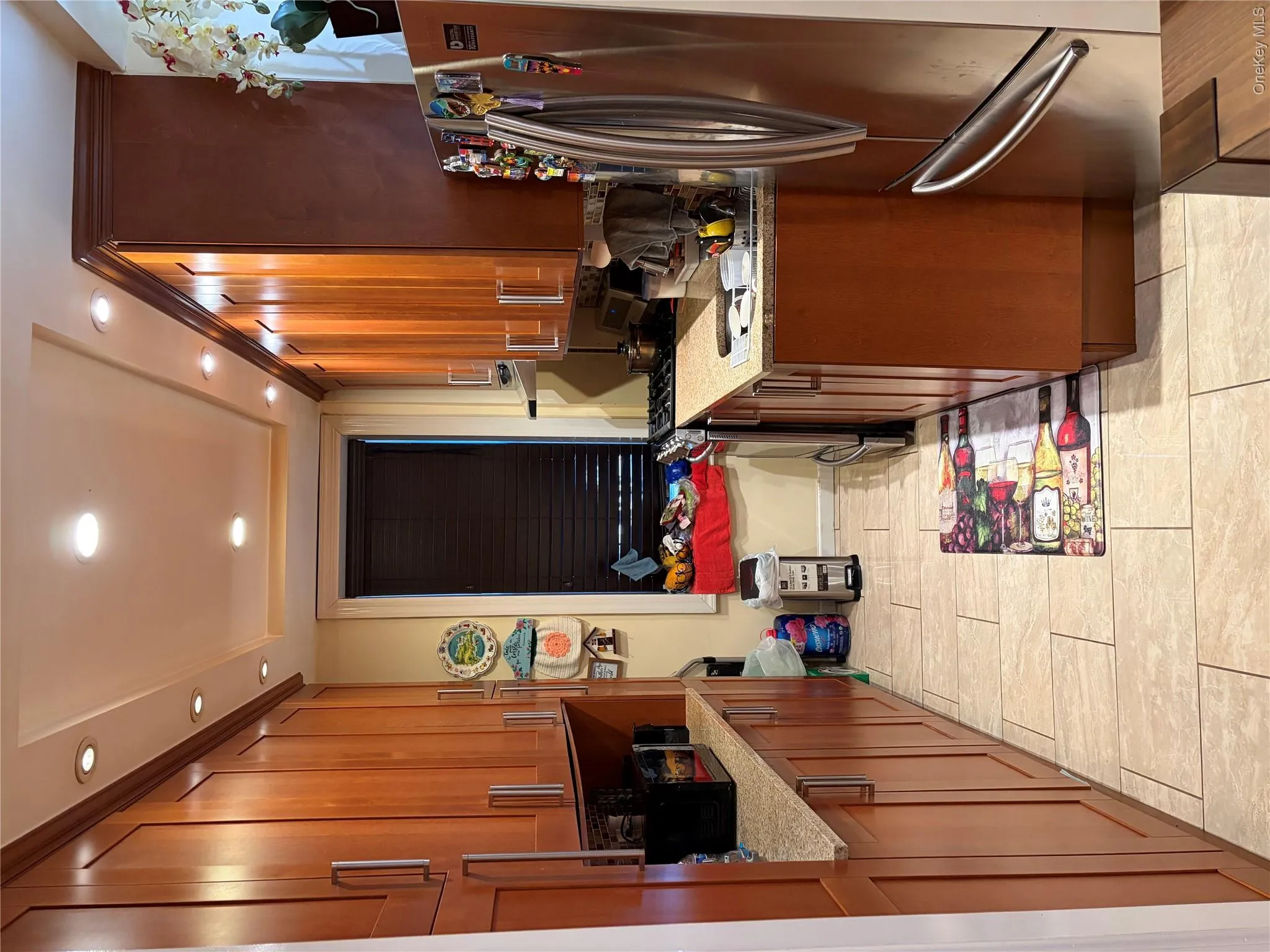 Front view of upgraded kitchen, cabinetry and marble tiles. Front view of upgraded kitchen, cabinetry and marble tiles.