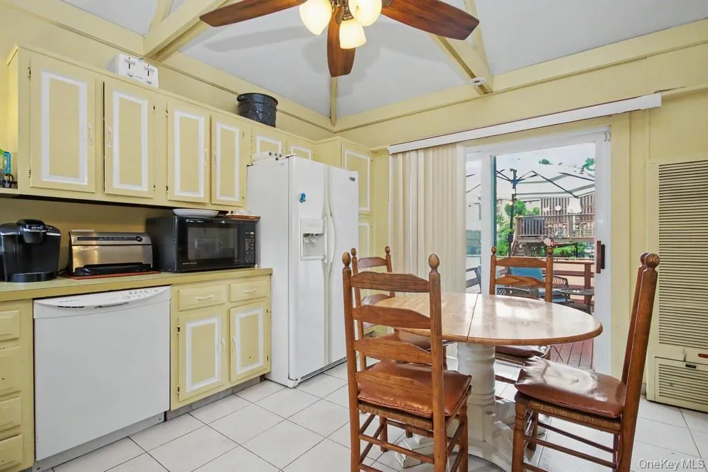 Kitchen's sliding glass doors to upper rear deck Kitchen's sliding glass doors to upper rear deck