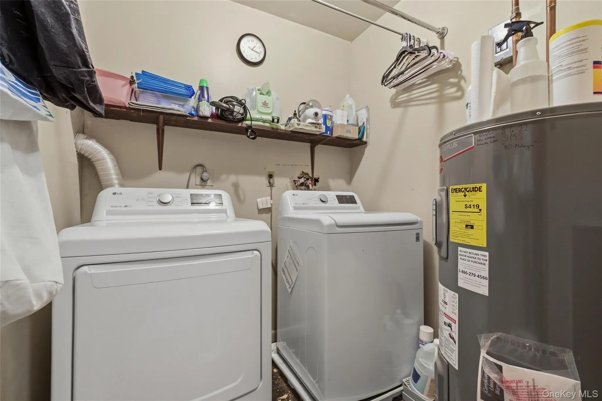 Dedicated utility space featuring a water heater and laundry appliances. Dedicated utility space featuring a water heater and laundry appliances.