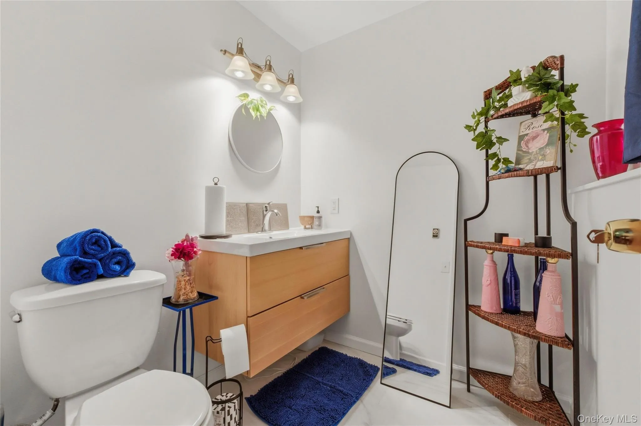 Modern vanity with wood-finish cabinetry, integrated sink, and contemporary faucet in half bathroom in basement Modern vanity with wood-finish cabinetry, integrated sink, and contemporary faucet in half bathroom in basement
