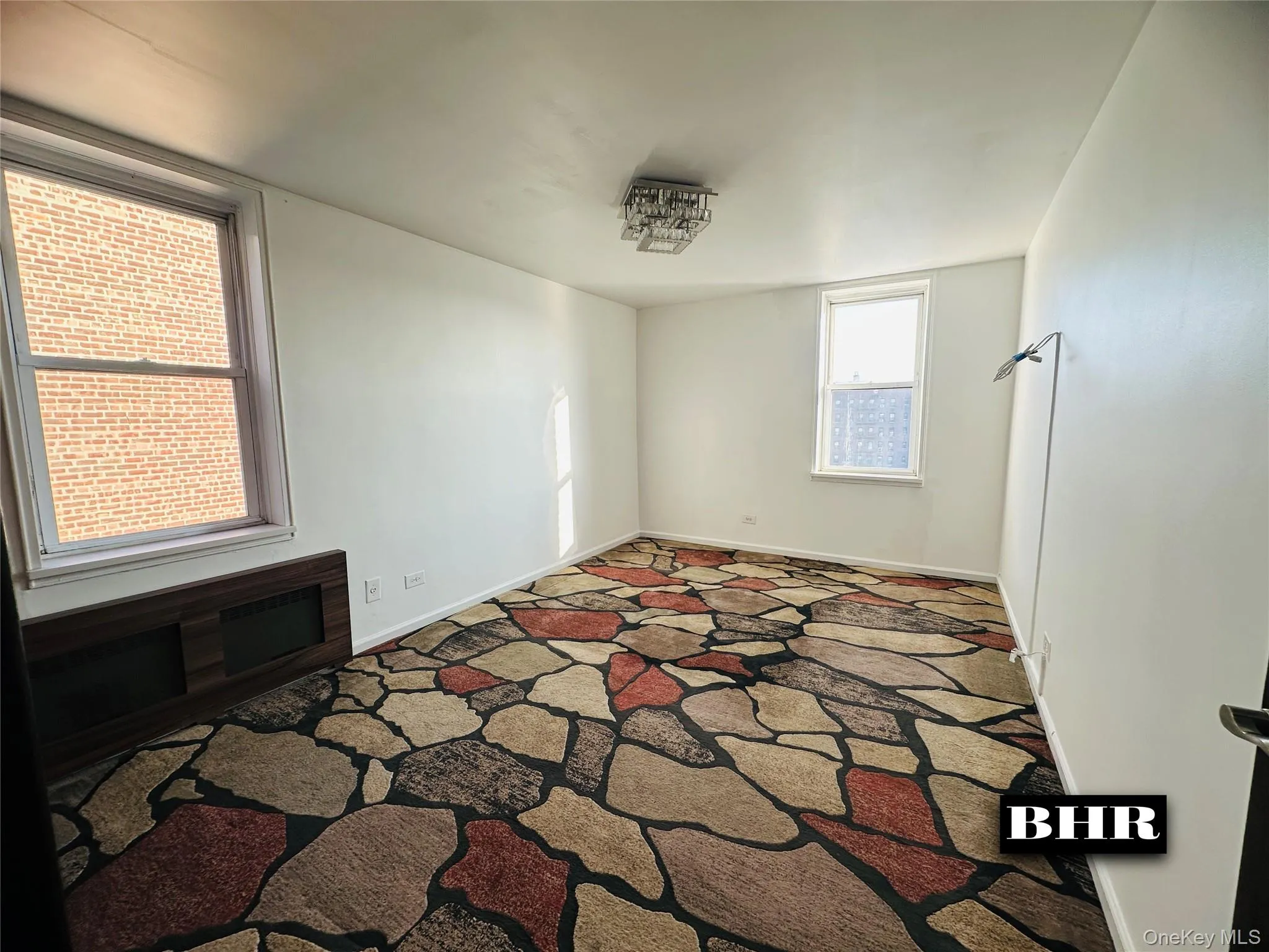 Empty room with carpet and baseboards Empty room with carpet and baseboards