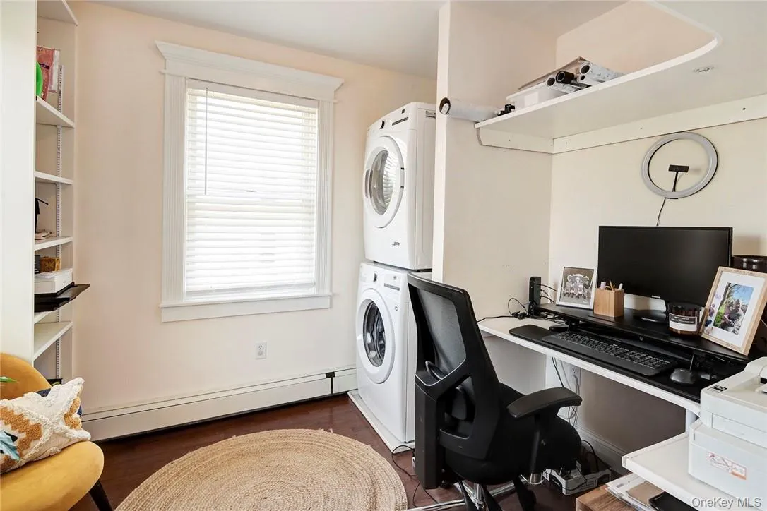 Second Lndry Rm/Office area with a baseboard radiator, stacked washer / dryer, storage..off Primary Bdrm Second Lndry Rm/Office area with a baseboard radiator, stacked washer / dryer, storage..off Primary Bdrm