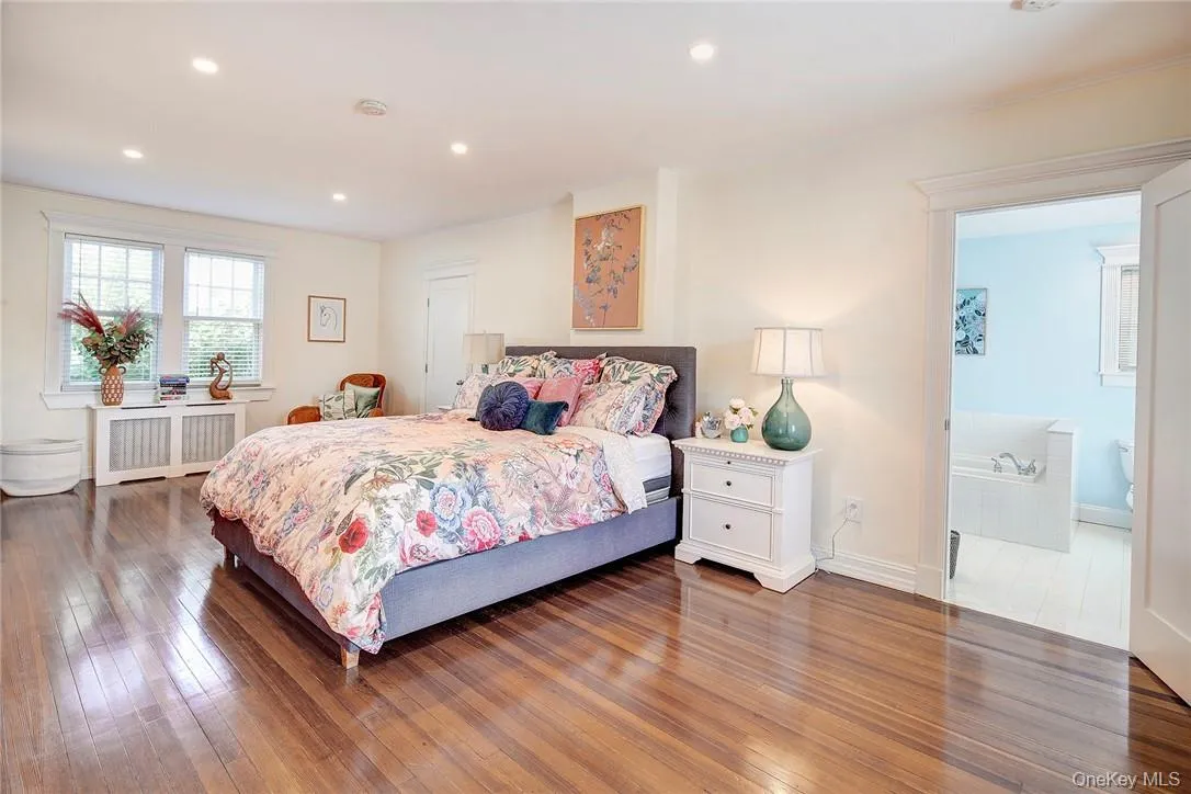 Spacious Primary Bedroom with hardwood flooring, radiator,4 closets, adjacent 2nd Lndry rm/closet, and recessed lighting Spacious Primary Bedroom with hardwood flooring, radiator,4 closets, adjacent 2nd Lndry rm/closet, and recessed lighting