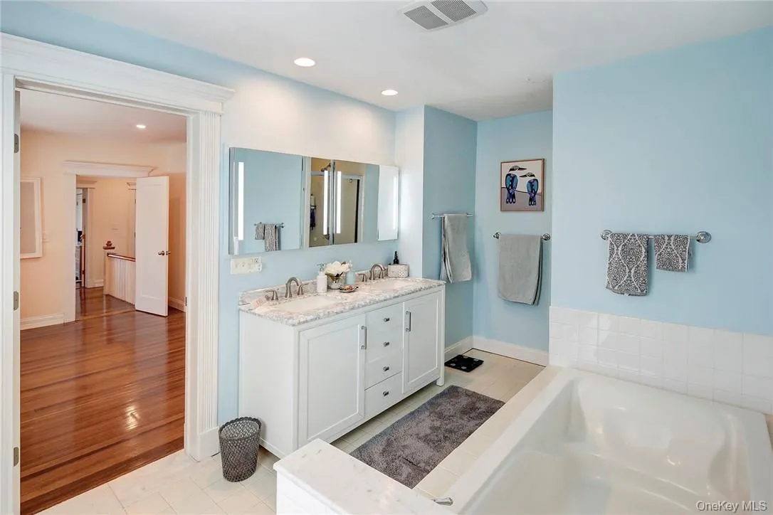 Renovated Primary Bathroom featuring double vanity, a garden tub, shower and recessed lighting, Renovated Primary Bathroom featuring double vanity, a garden tub, shower and recessed lighting,