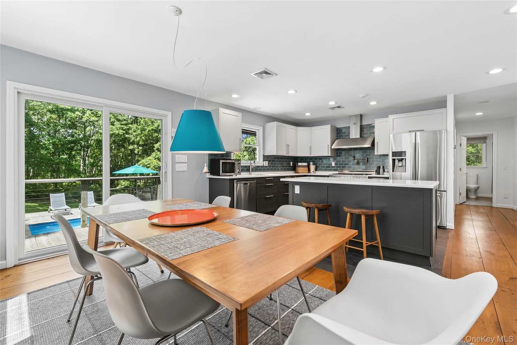 Open-concept kitchen and dining area featuring a two-toned cabinetry design Open-concept kitchen and dining area featuring a two-toned cabinetry design