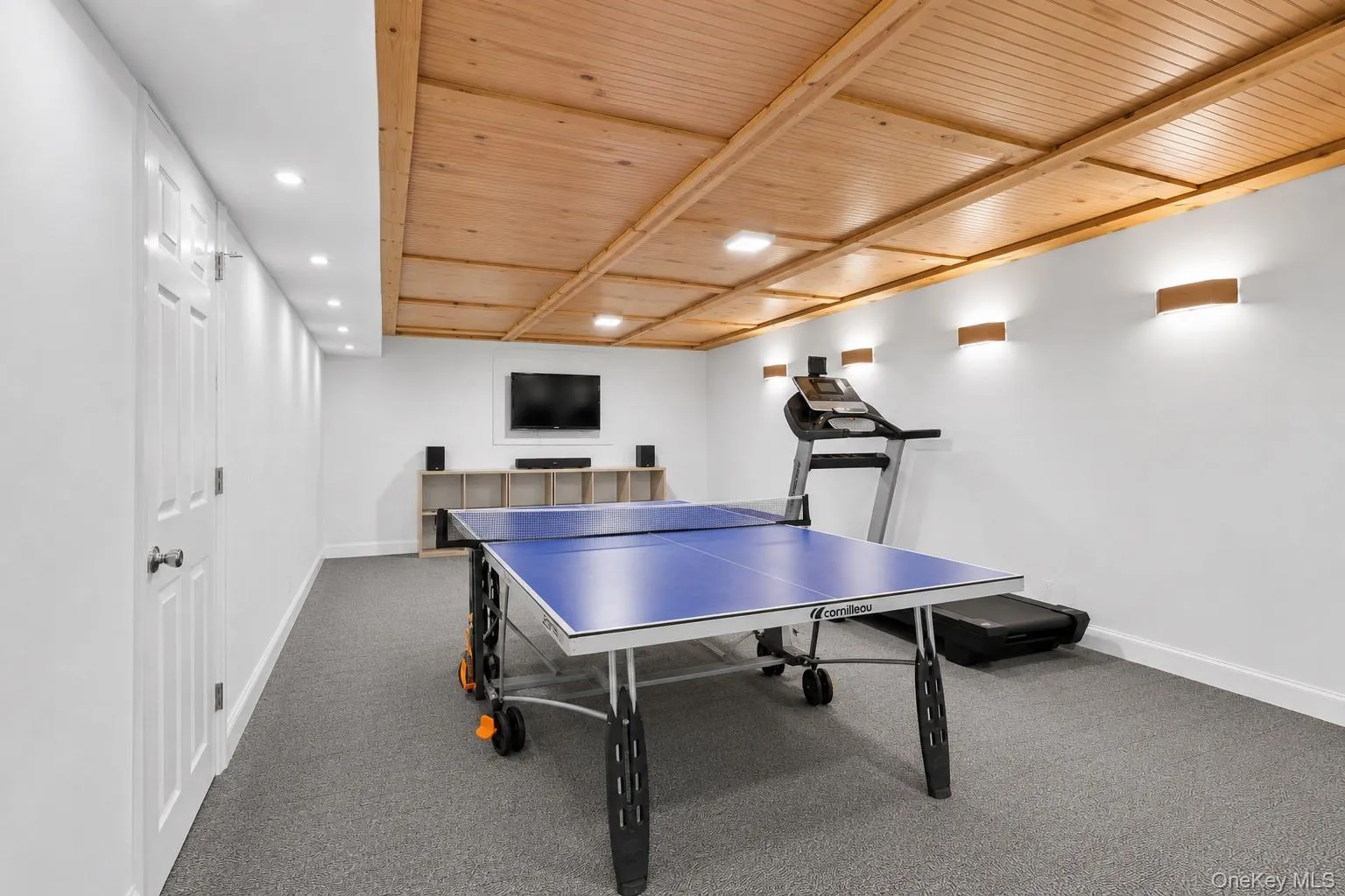 Recreation room featuring a paneled wood ceiling with recessed lighting and wall sconces Recreation room featuring a paneled wood ceiling with recessed lighting and wall sconces