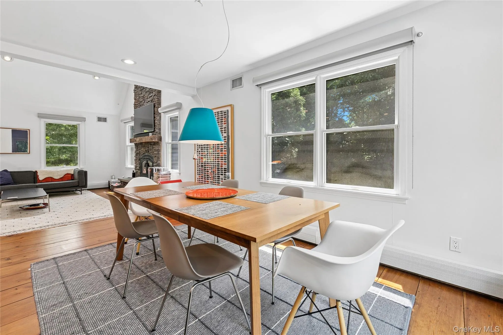 Spacious dining area with wood-finish flooring and two large windows Spacious dining area with wood-finish flooring and two large windows