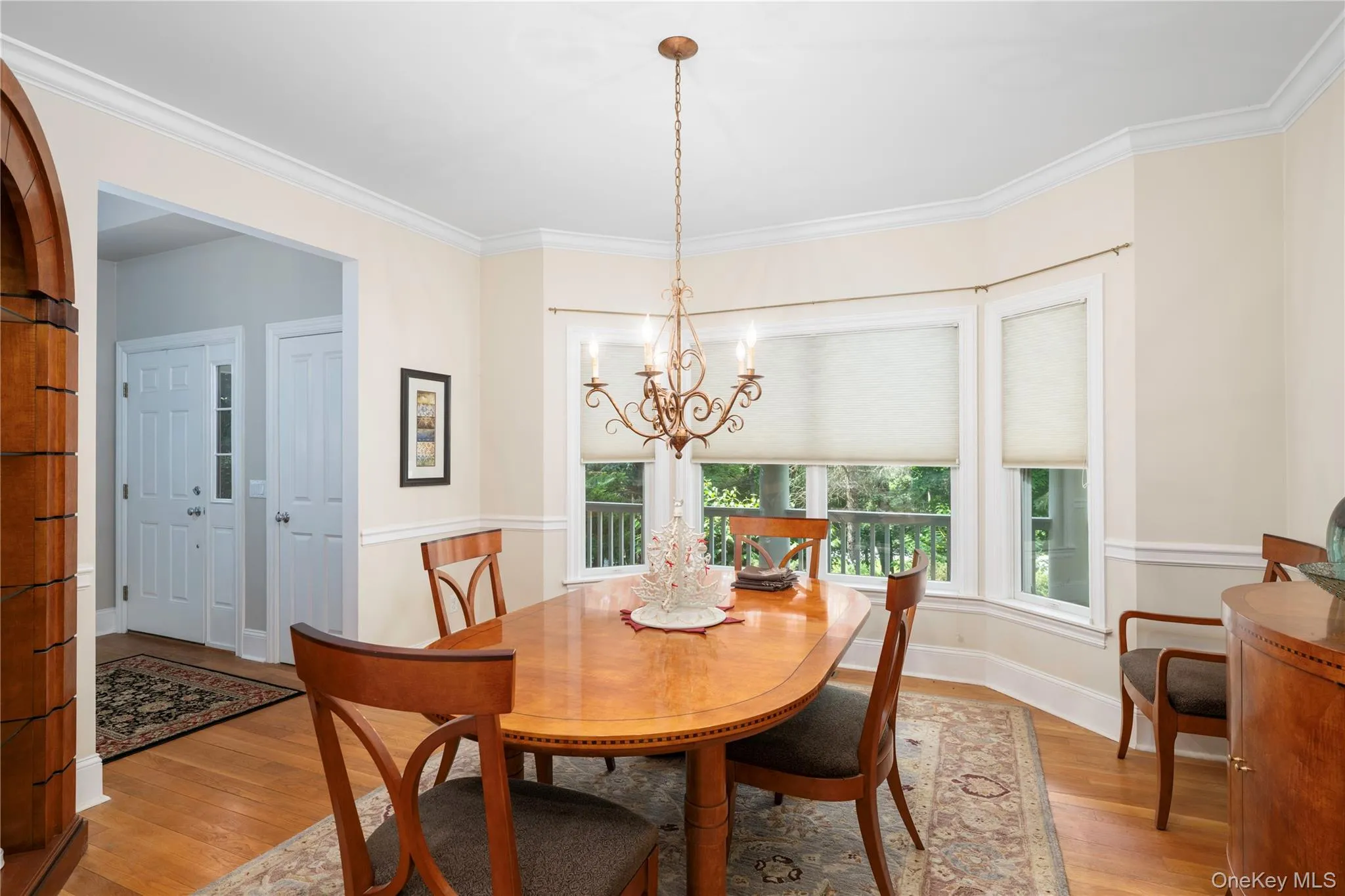 Formal dining area with bay windows featuring individual window treatments Formal dining area with bay windows featuring individual window treatments