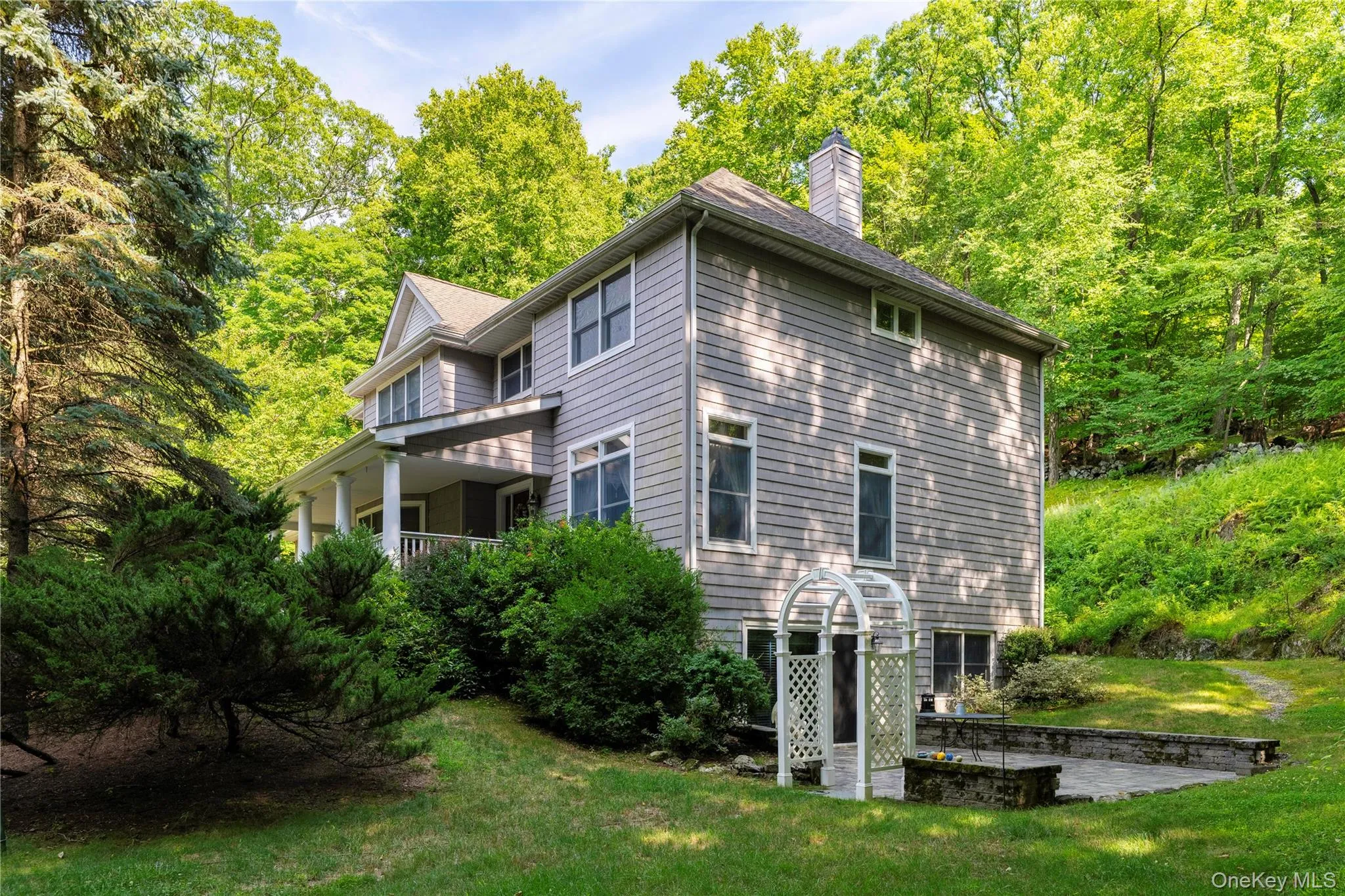 Gray clapboard exterior with white trim and a covered porch Gray clapboard exterior with white trim and a covered porch