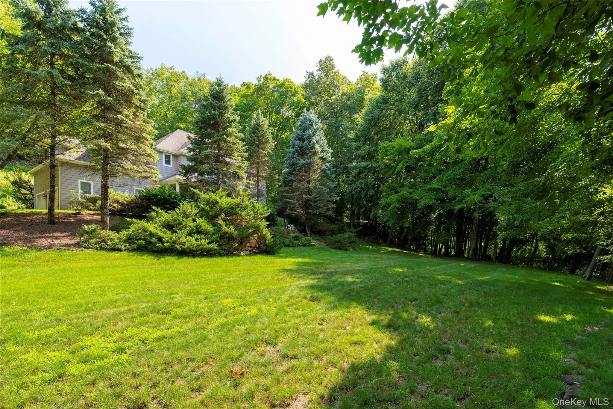Expansive lawn area with mature trees and established landscaping Expansive lawn area with mature trees and established landscaping