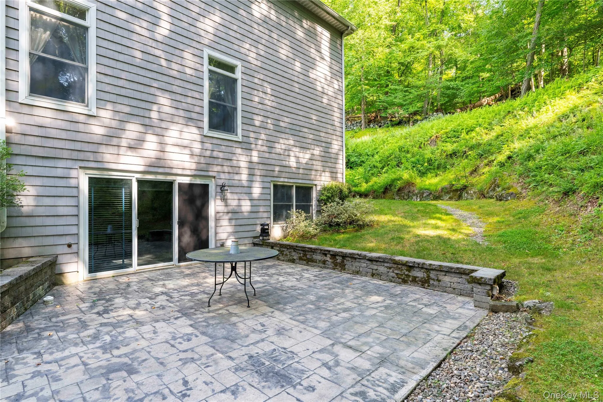 Expansive stamped concrete patio with stone retaining walls Expansive stamped concrete patio with stone retaining walls