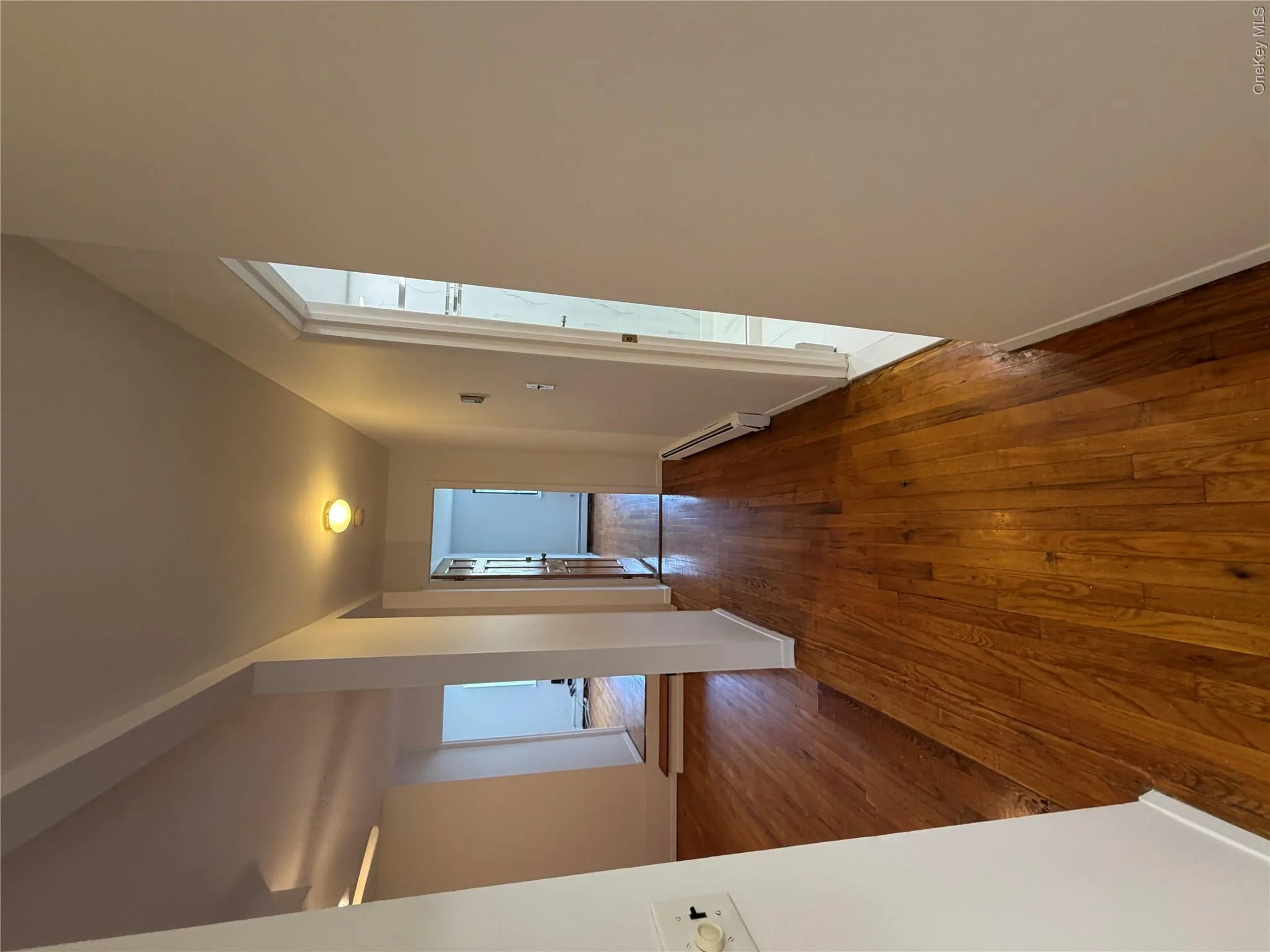 Hardwood flooring throughout the hallway and adjacent rooms Hardwood flooring throughout the hallway and adjacent rooms