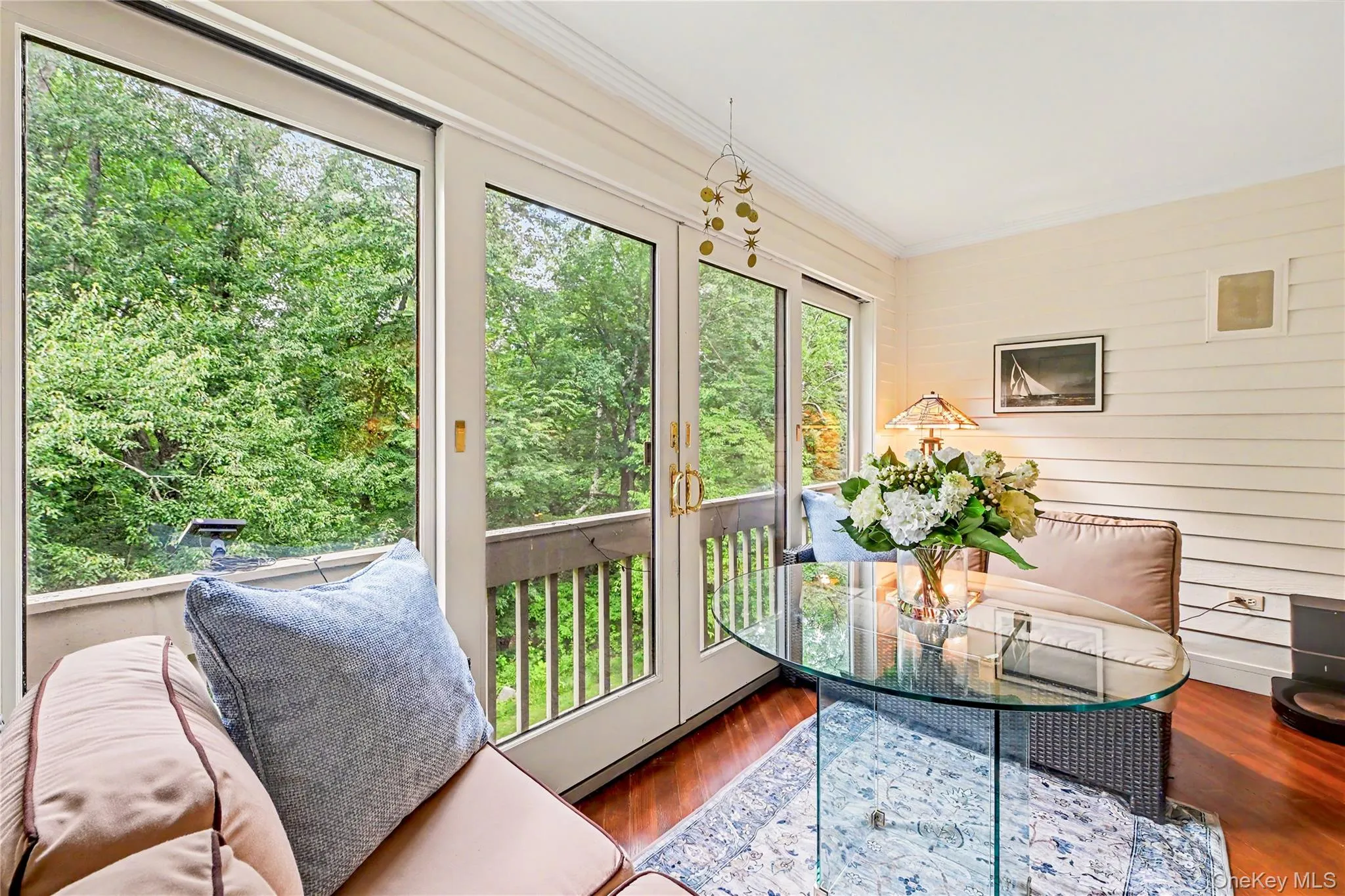 Three-season enclosed porch with wooded views. Three-season enclosed porch with wooded views.