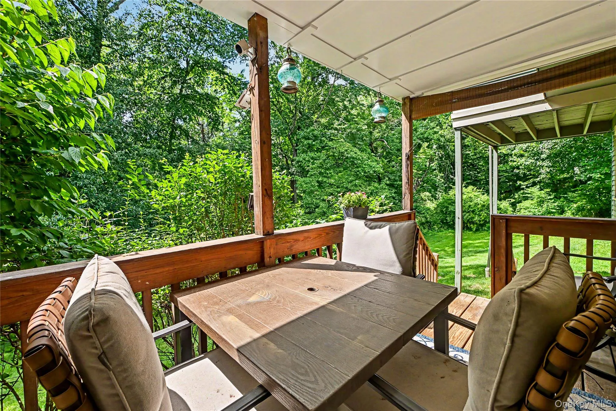 Primary bedroom deck with wooded views and access to the lawn. Primary bedroom deck with wooded views and access to the lawn.