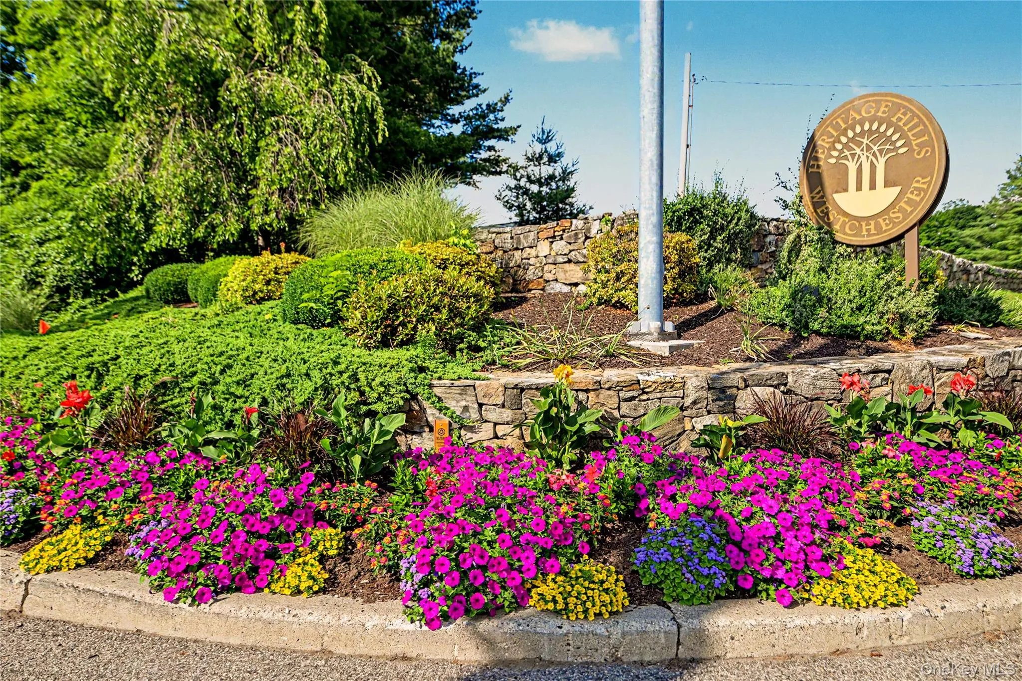Come home to Heritage Hills. Main entry to Heritage Hills with beautiful seasonal plantings. Come home to Heritage Hills. Main entry to Heritage Hills with beautiful seasonal plantings.